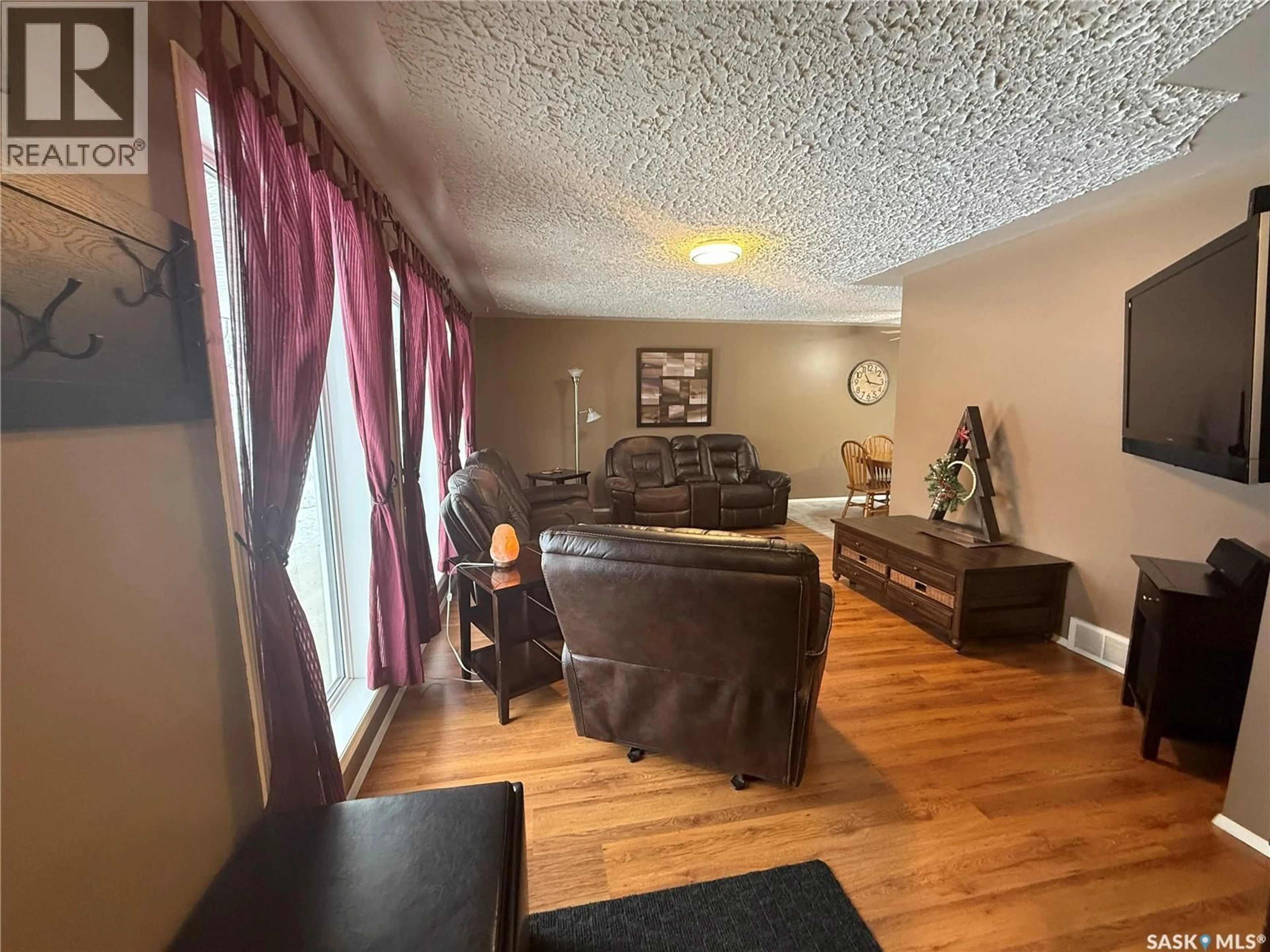 Living room with furniture, wood/laminate floor for 714 2ND AVENUE, Annaheim Saskatchewan S0K0G0