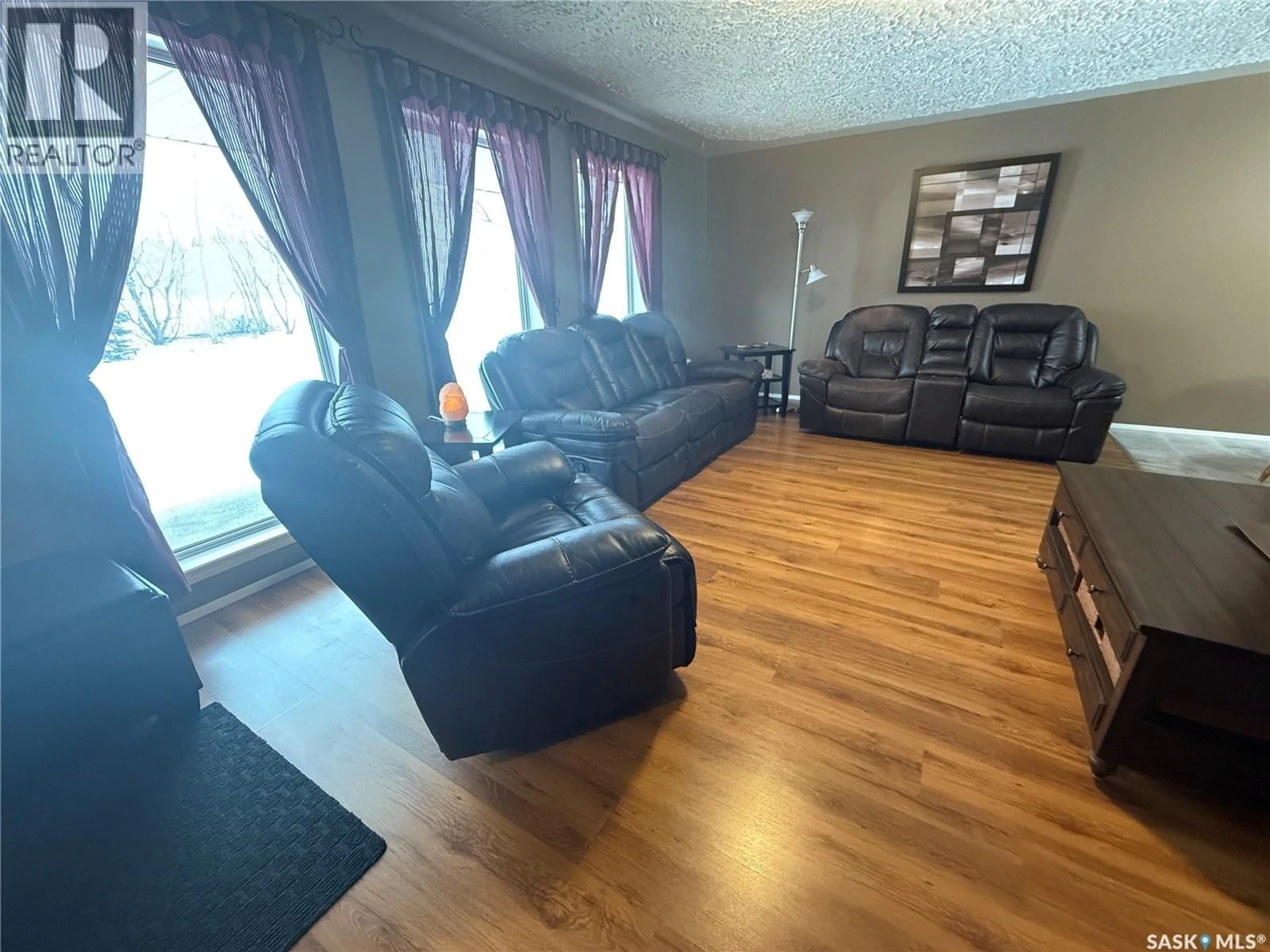 Living room with furniture, wood/laminate floor for 714 2ND AVENUE, Annaheim Saskatchewan S0K0G0