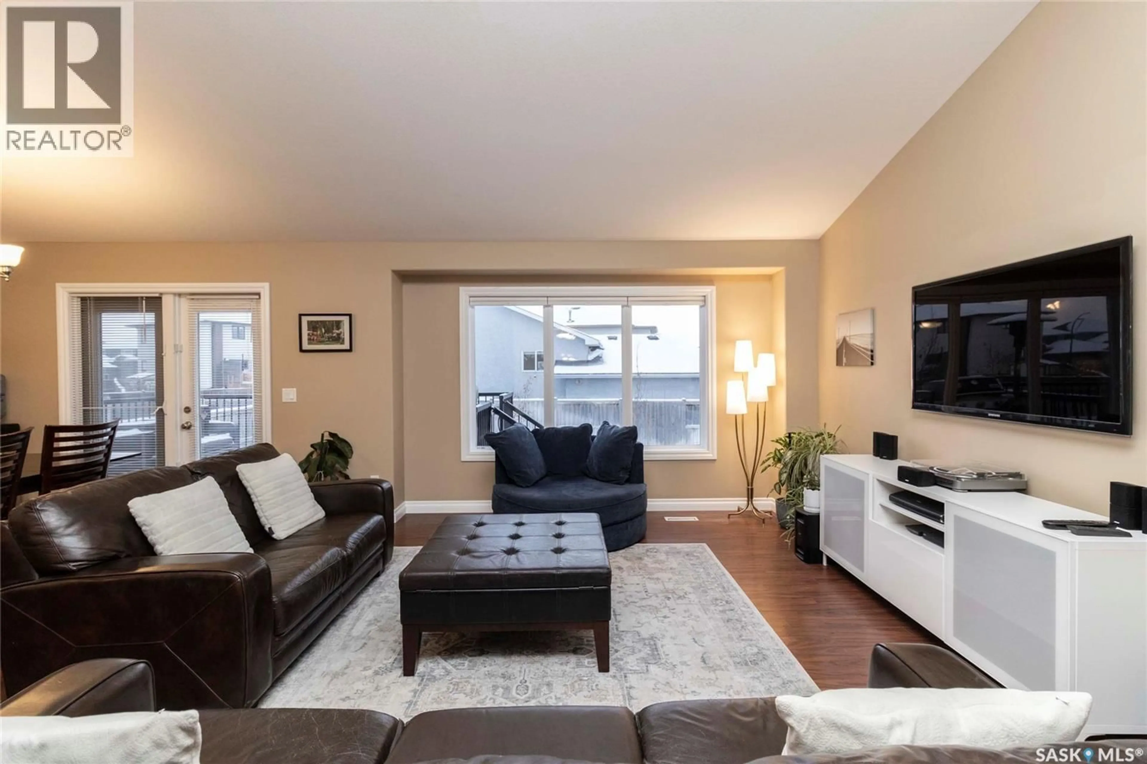 Living room with furniture, wood/laminate floor for 102 KEEDWELL STREET, Saskatoon Saskatchewan S7W1B4