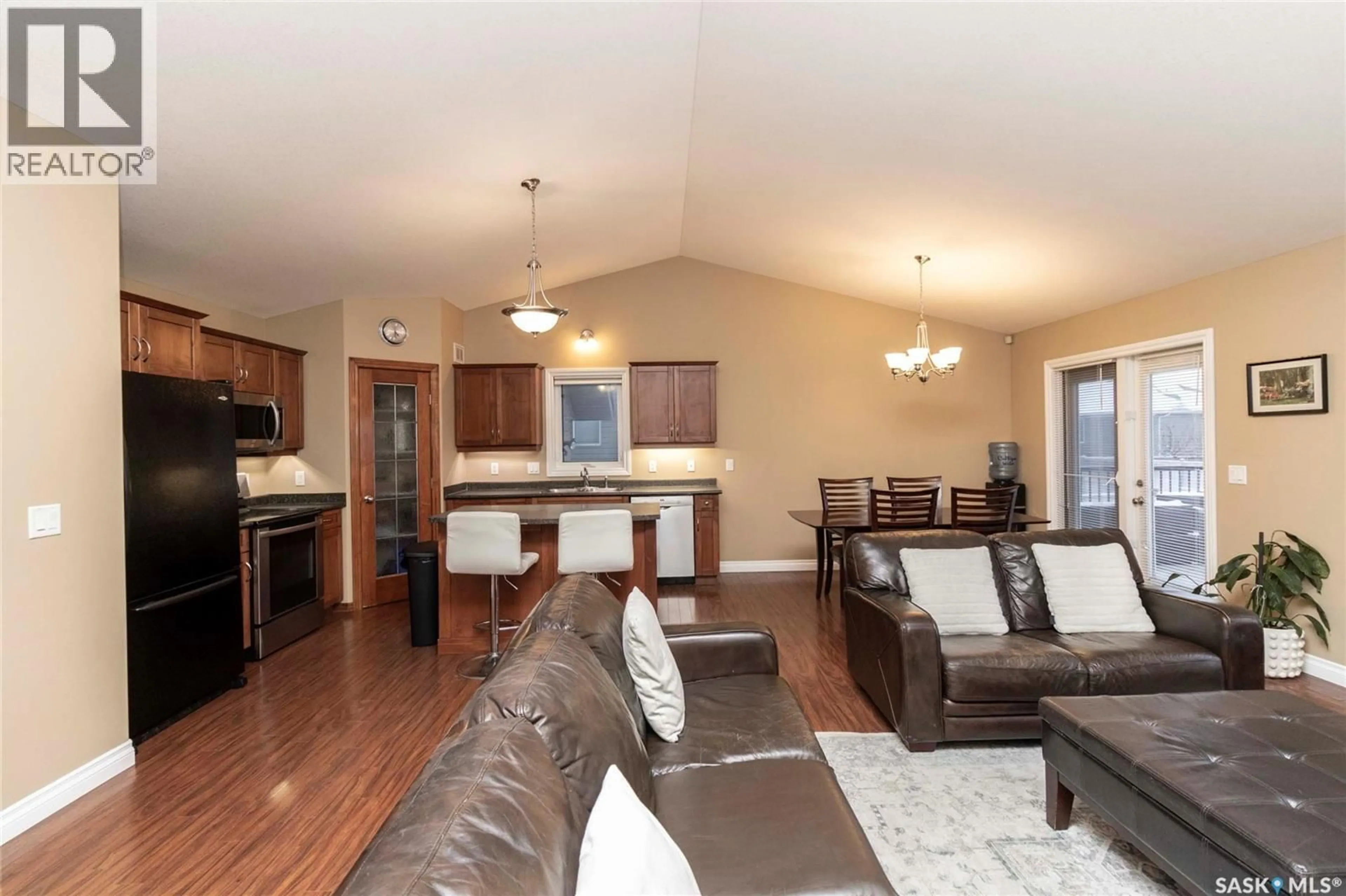 Open concept kitchen, wood/laminate floor for 102 KEEDWELL STREET, Saskatoon Saskatchewan S7W1B4