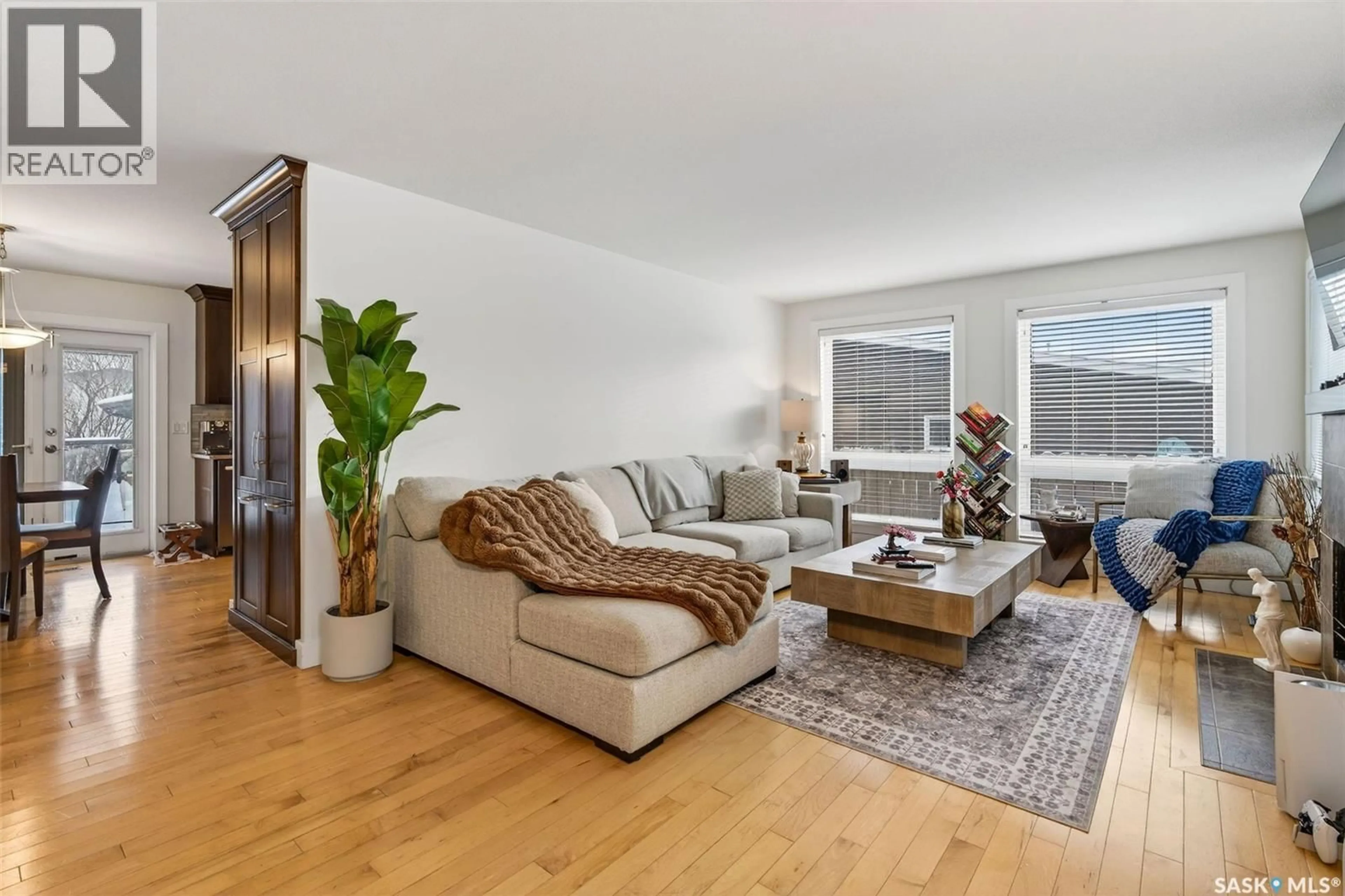 Living room with furniture, wood/laminate floor for 418 TENNANT WAY, Saskatoon Saskatchewan S7H5C4