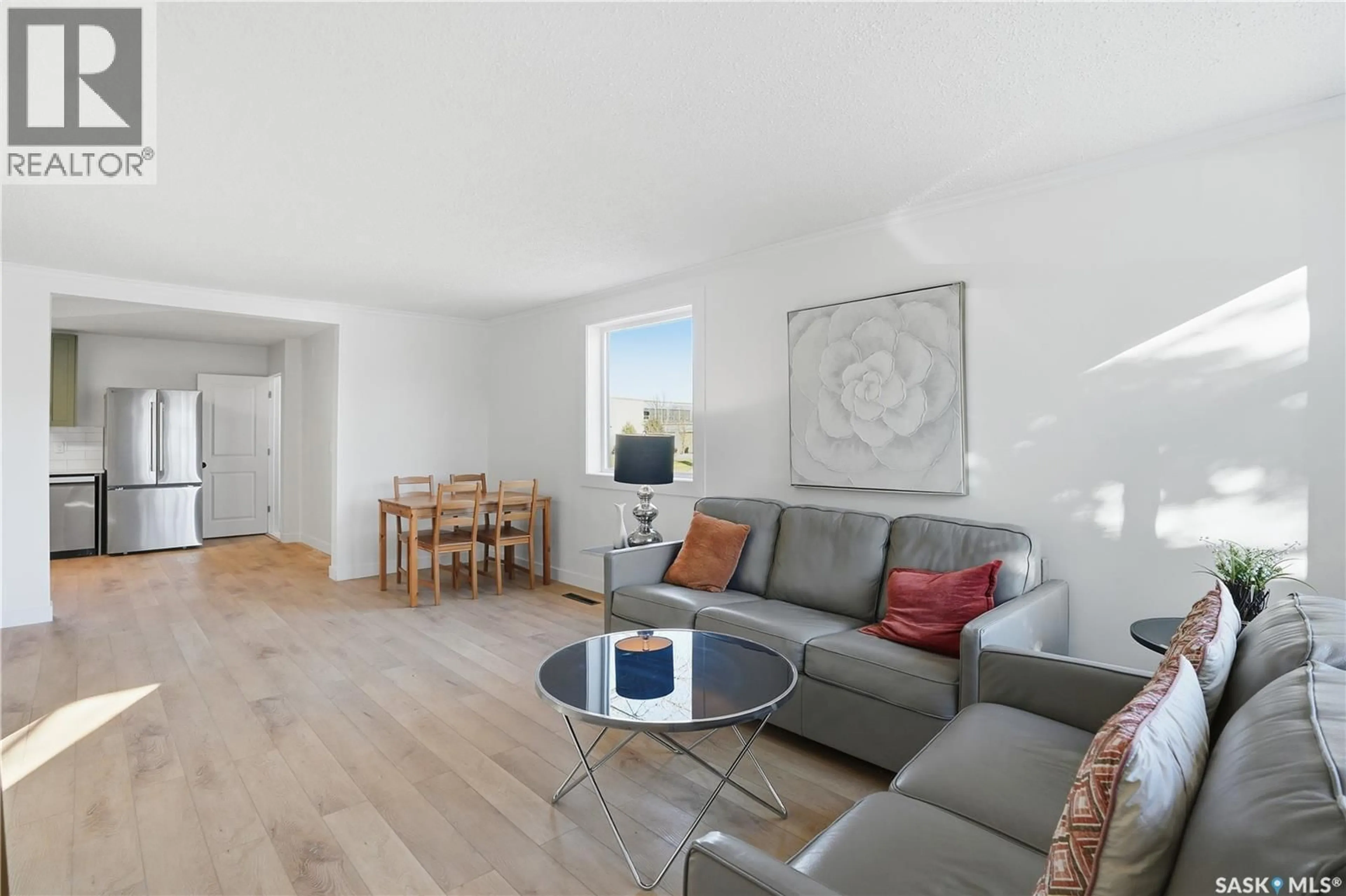 Living room with furniture, wood/laminate floor for 100 32ND STREET, Saskatoon Saskatchewan S7L0S1