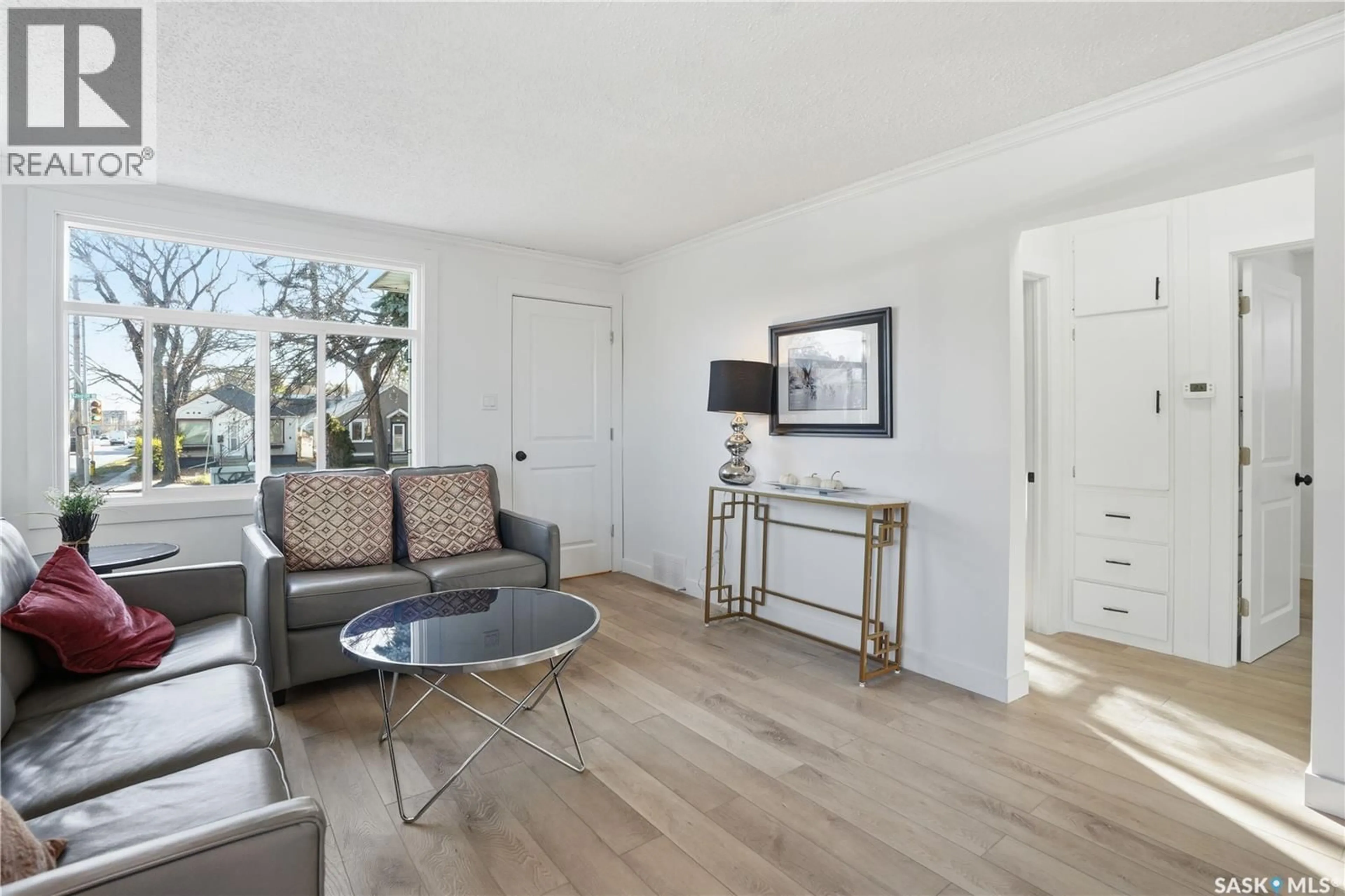 Living room with furniture, wood/laminate floor for 100 32ND STREET, Saskatoon Saskatchewan S7L0S1