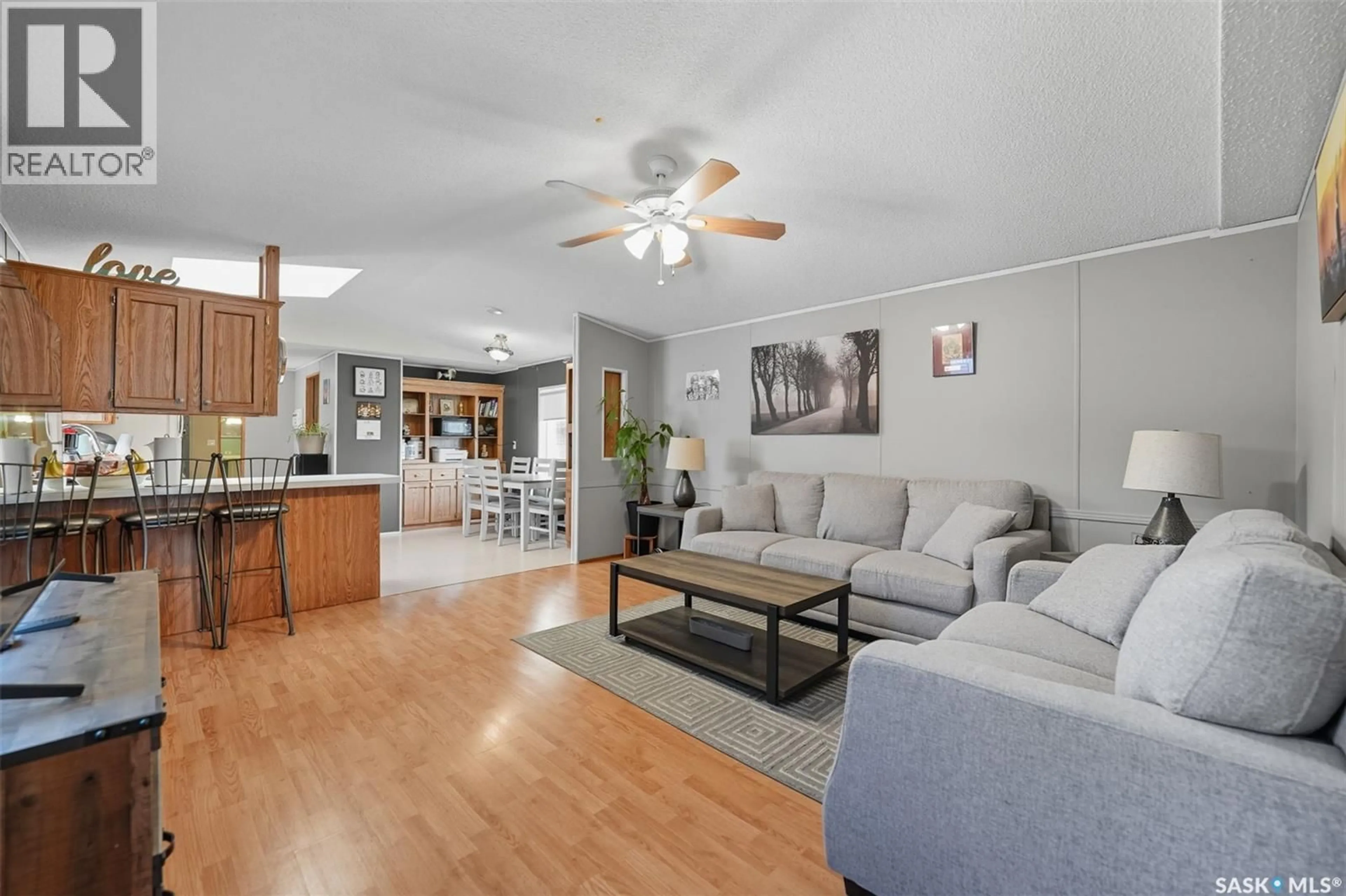 Living room with furniture, wood/laminate floor for 1035 - 28 BOYCHUK DRIVE, Saskatoon Saskatchewan S7H5B2