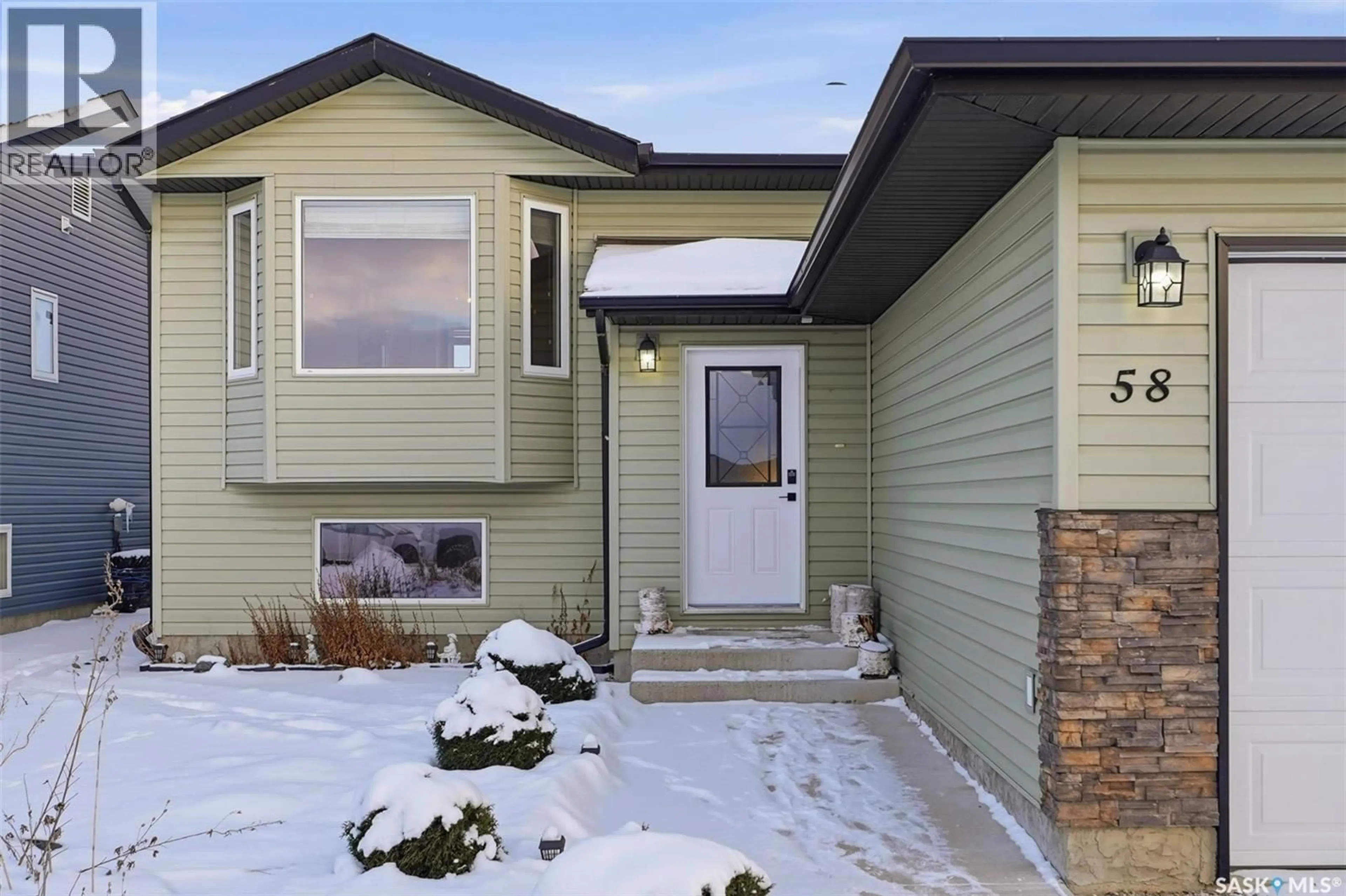 Home with vinyl exterior material, street for 58 RAIDER BAY, Prince Albert Saskatchewan S6V1H6