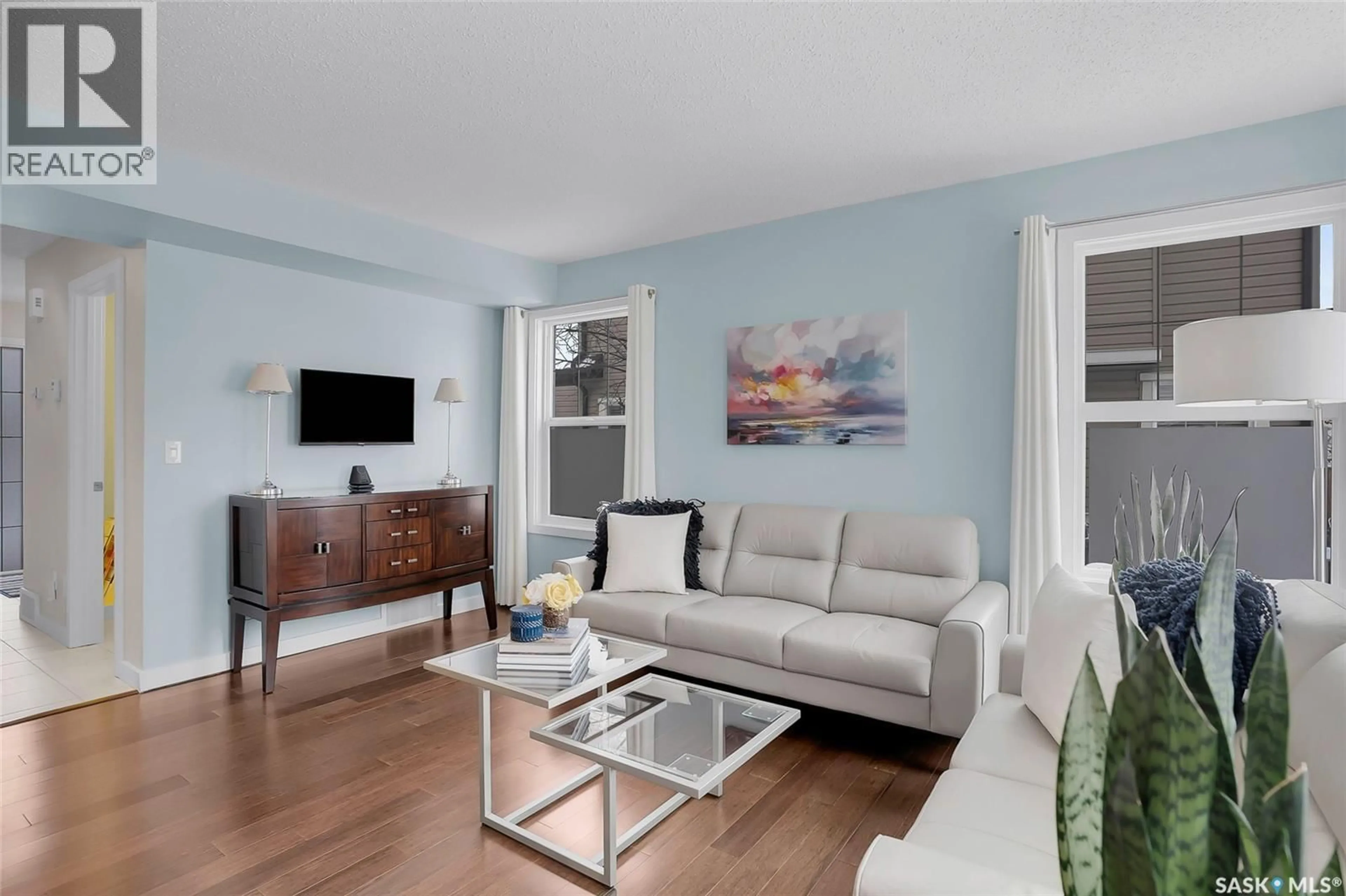 Living room with furniture, wood/laminate floor for 410 - 318 LEDINGHAM WAY, Saskatoon Saskatchewan S7V0C4