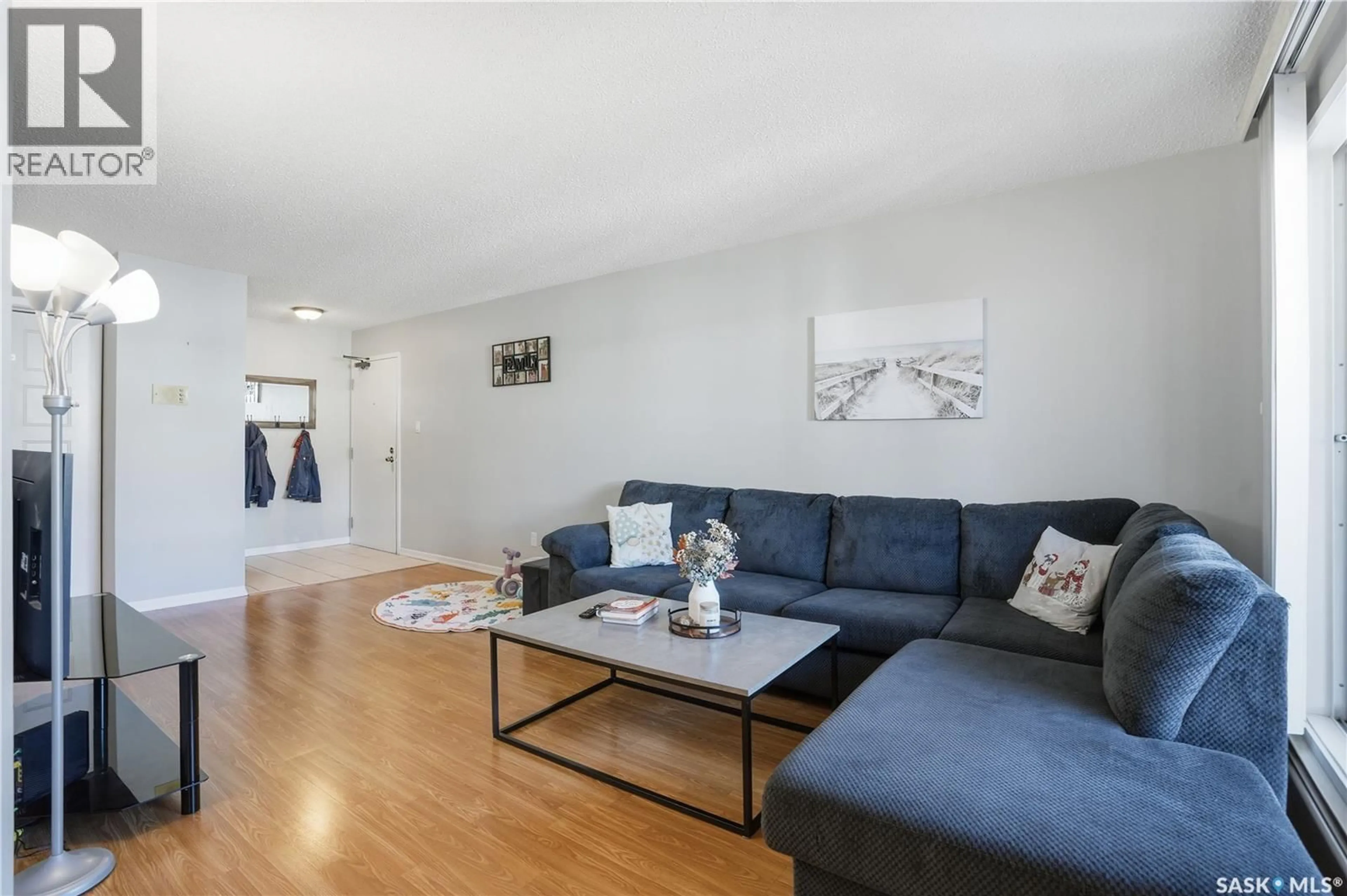 Living room with furniture, wood/laminate floor for 309A - 301 CREE CRESCENT, Saskatoon Saskatchewan S7K7Y3