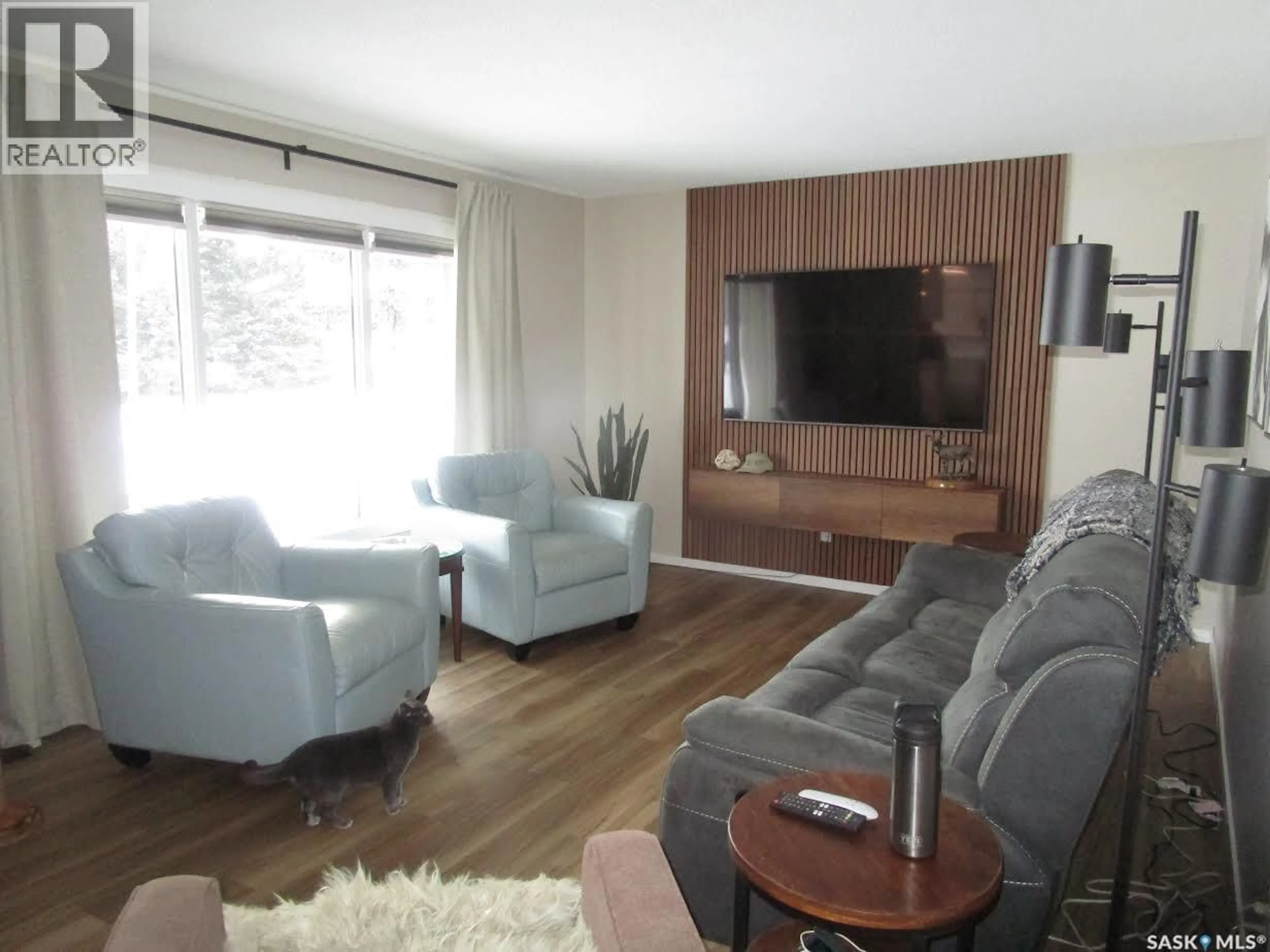 Living room with furniture, wood/laminate floor for 249 6TH AVENUE, Gravelbourg Saskatchewan S0H1X0