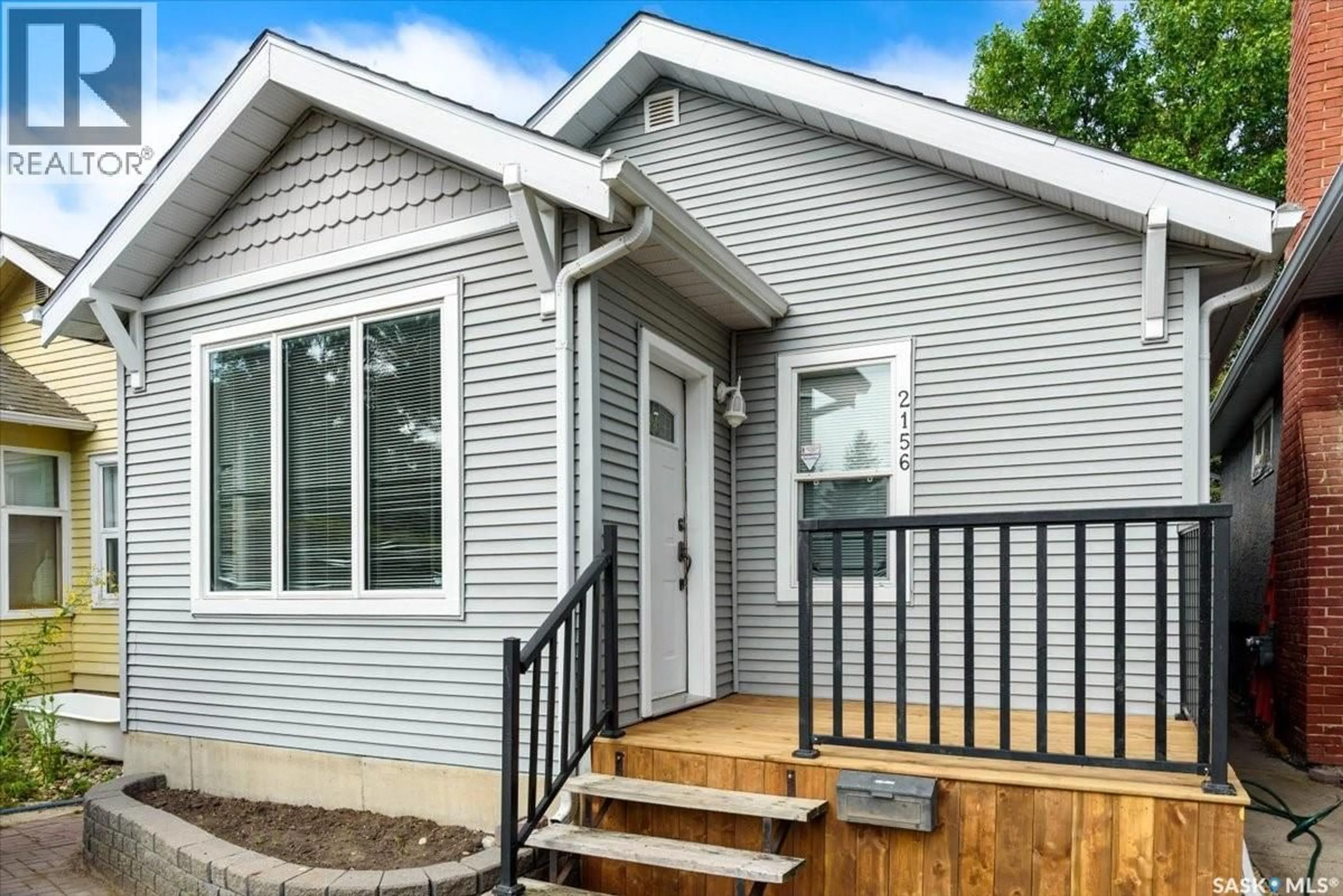 Home with vinyl exterior material, street for 2156 QUEEN STREET, Regina Saskatchewan S4T4C3