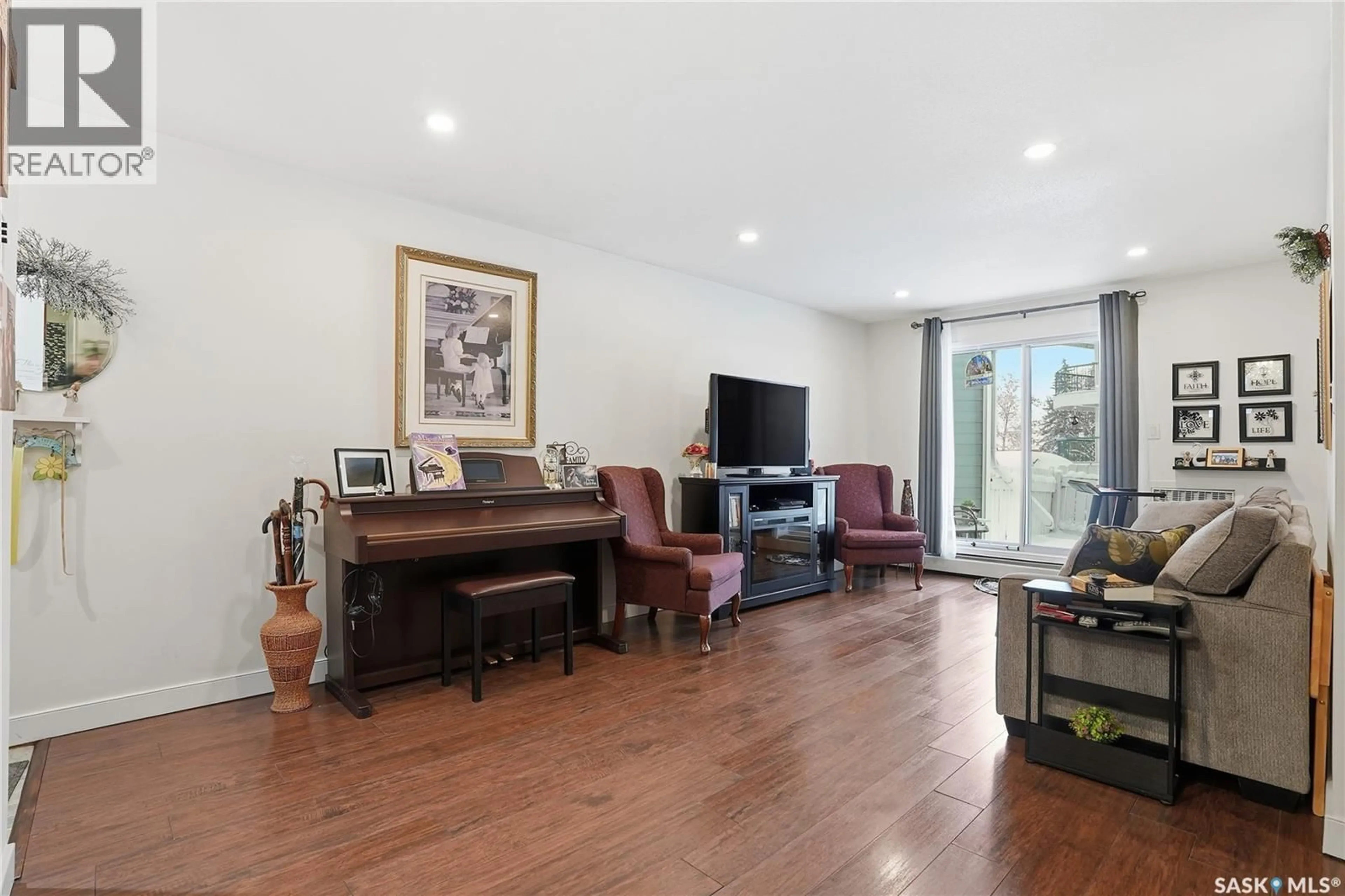 Living room with furniture, wood/laminate floor for 309A - 104 CREE CRESCENT, Saskatoon Saskatchewan S7K7Y3