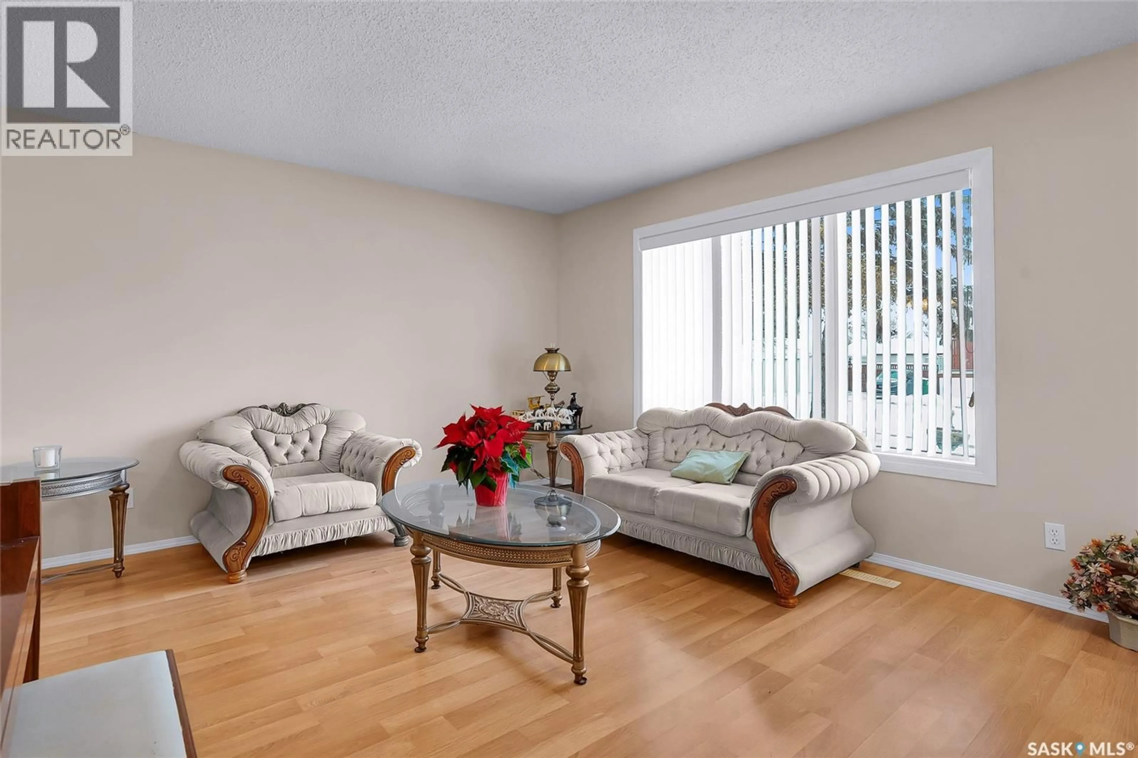 Living room with furniture, wood/laminate floor for 407 BOWMAN CRESCENT, Saskatoon Saskatchewan S7L6P7