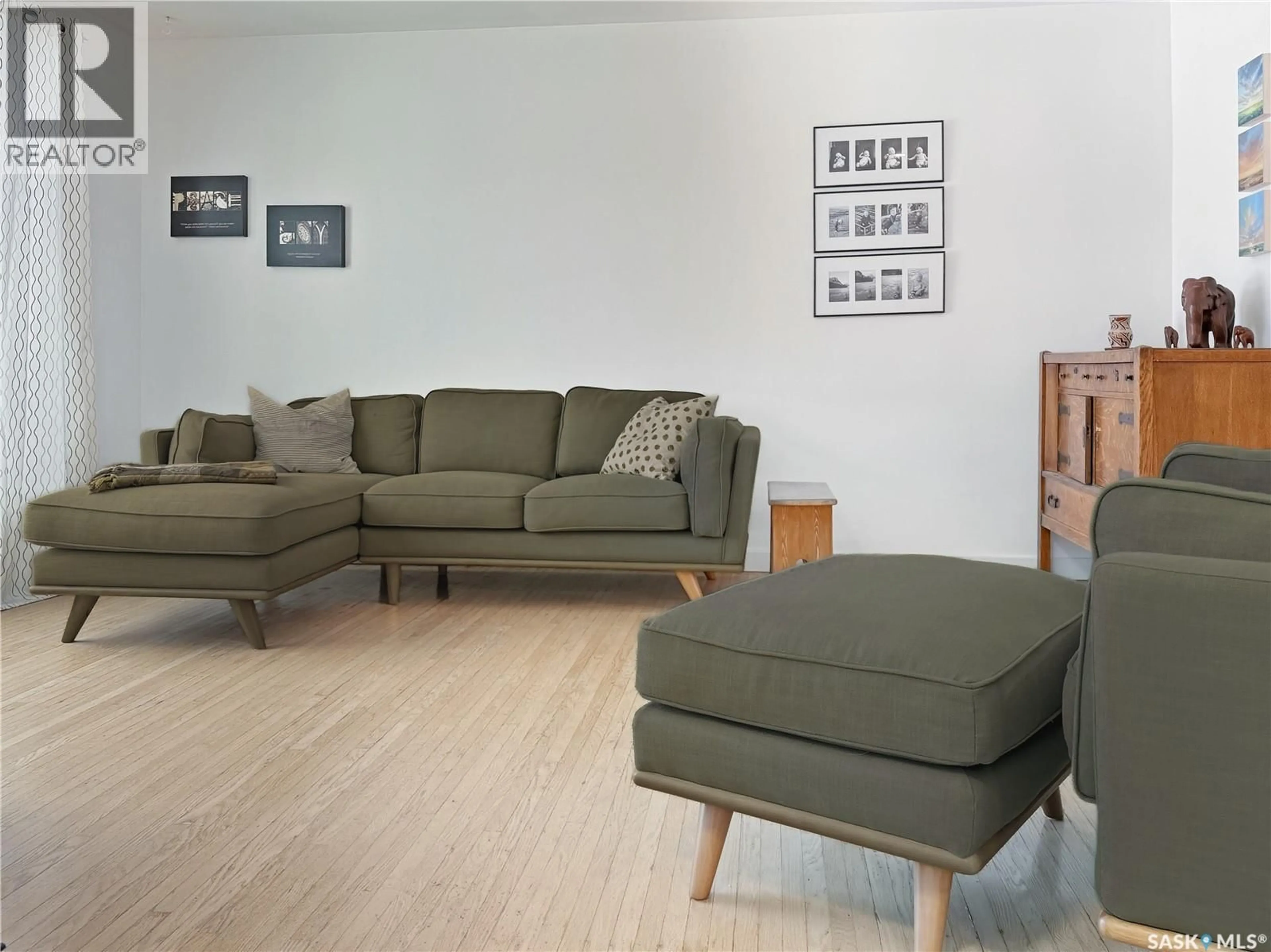 Living room with furniture, wood/laminate floor for 1551 92ND STREET, North Battleford Saskatchewan S9A0B2