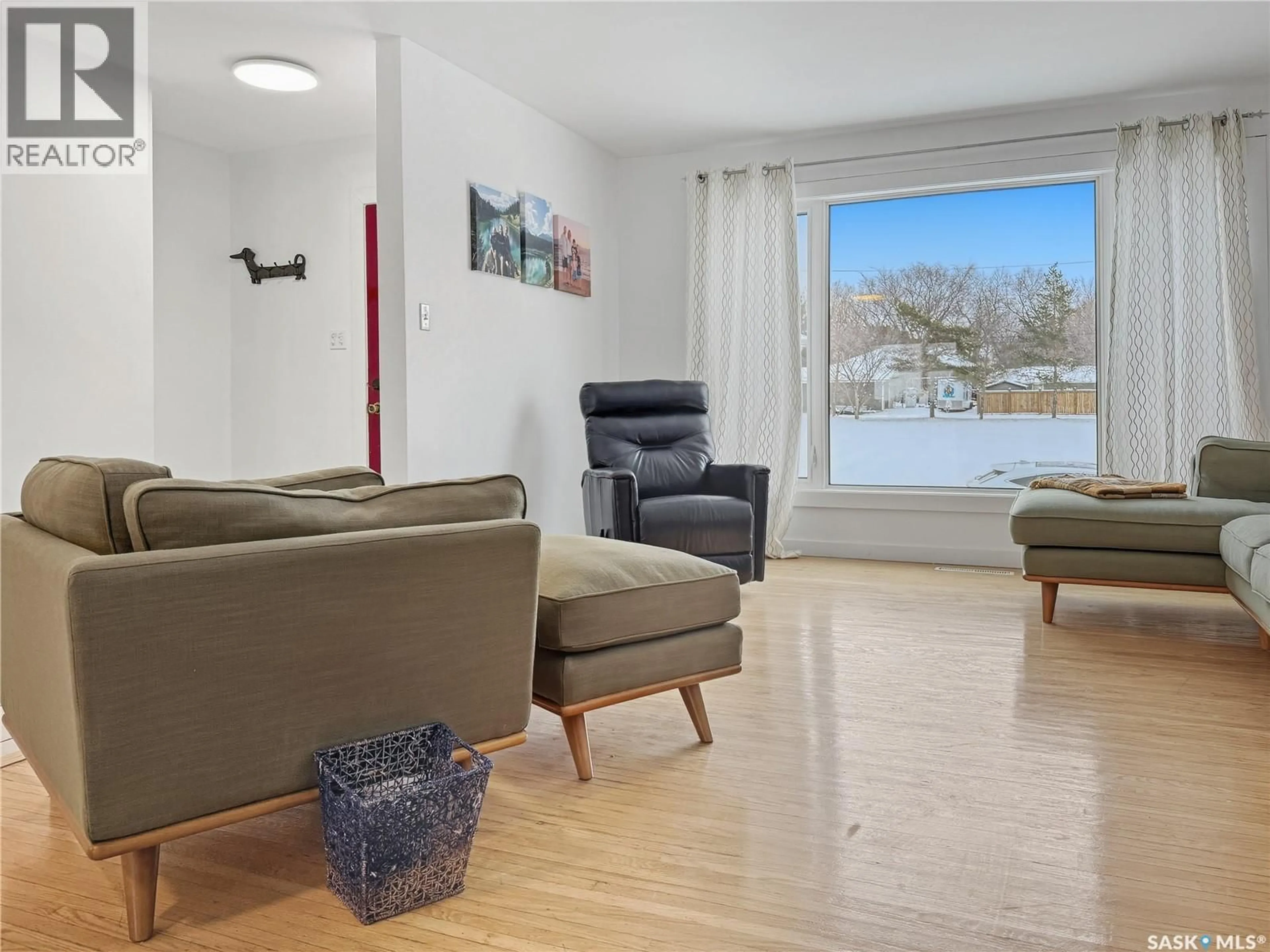 Living room with furniture, wood/laminate floor for 1551 92ND STREET, North Battleford Saskatchewan S9A0B2