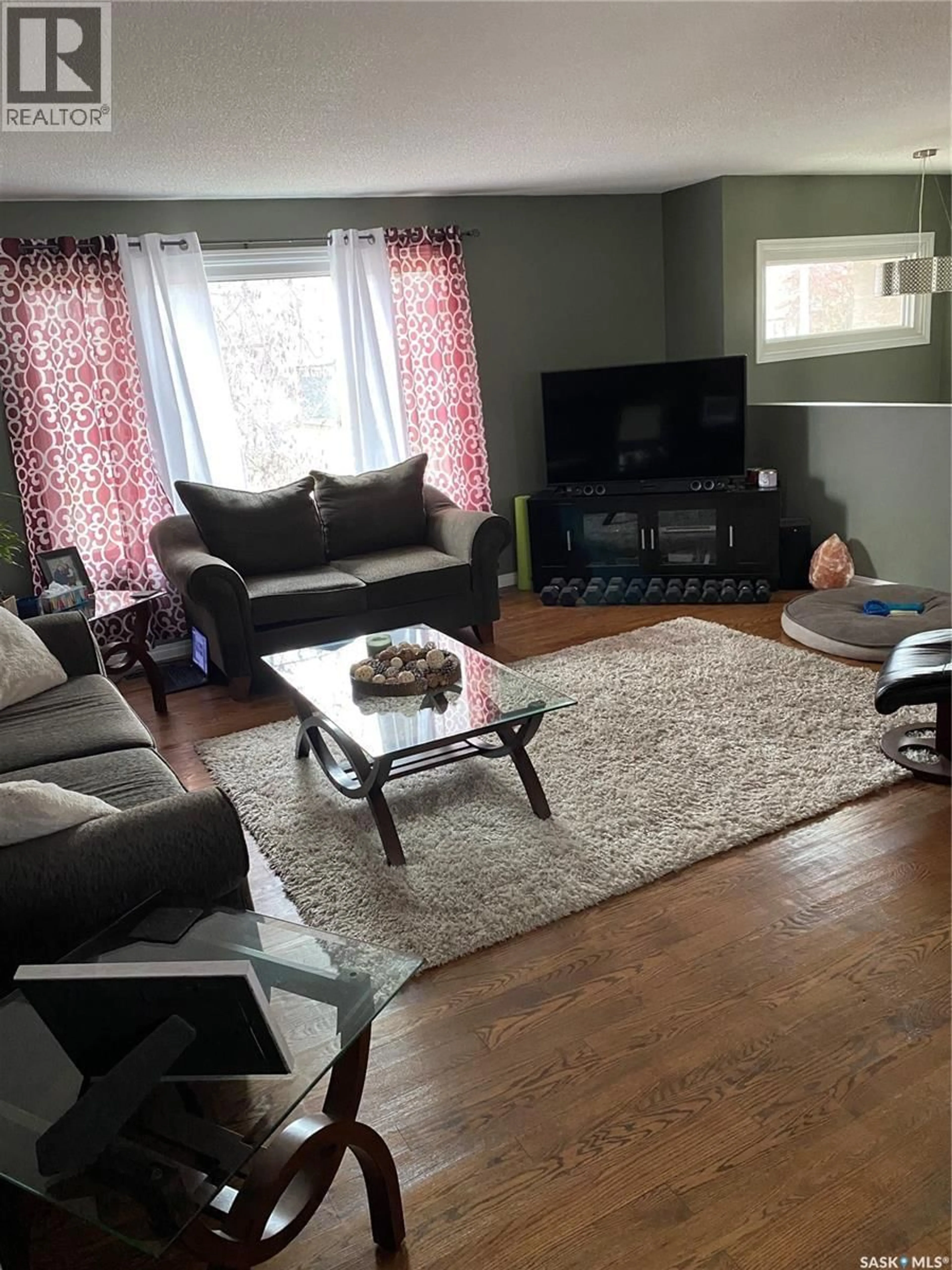 Living room with furniture, wood/laminate floor for 5 CARDINAL BAY, Yorkton Saskatchewan S3N3E4