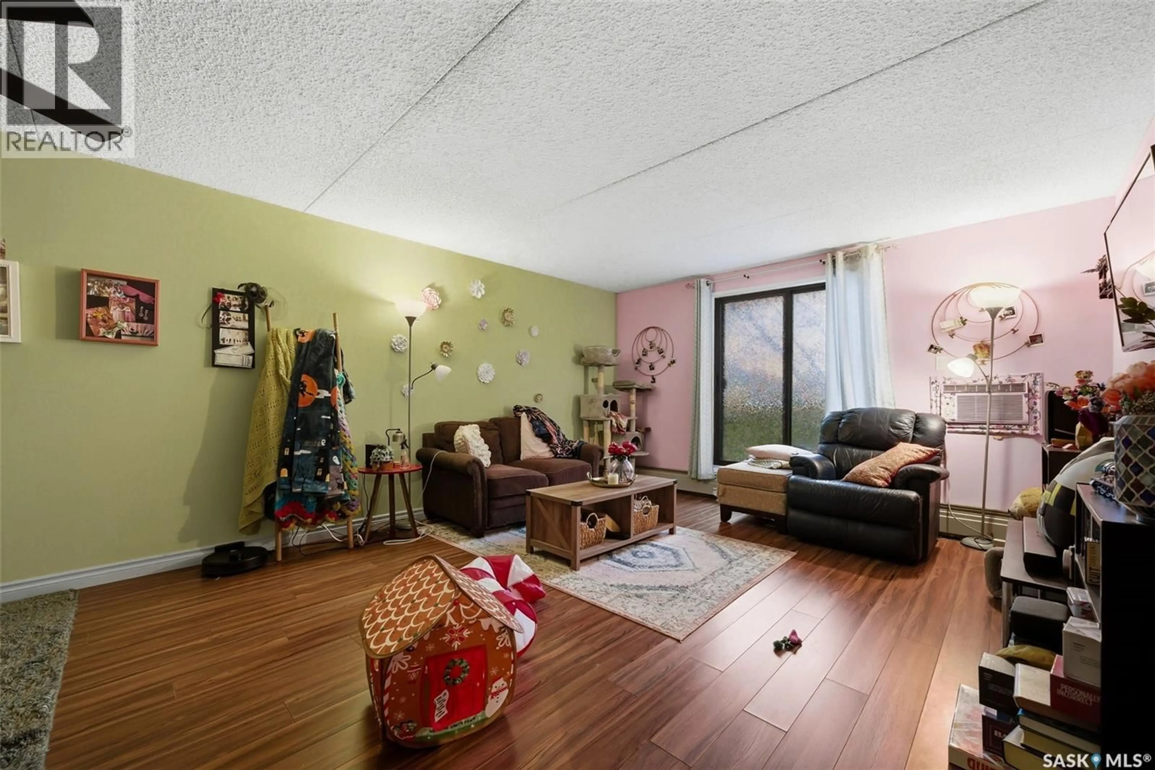 Living room with furniture, wood/laminate floor for 213 2125 OSLER STREET, Regina Saskatchewan S4P4G7