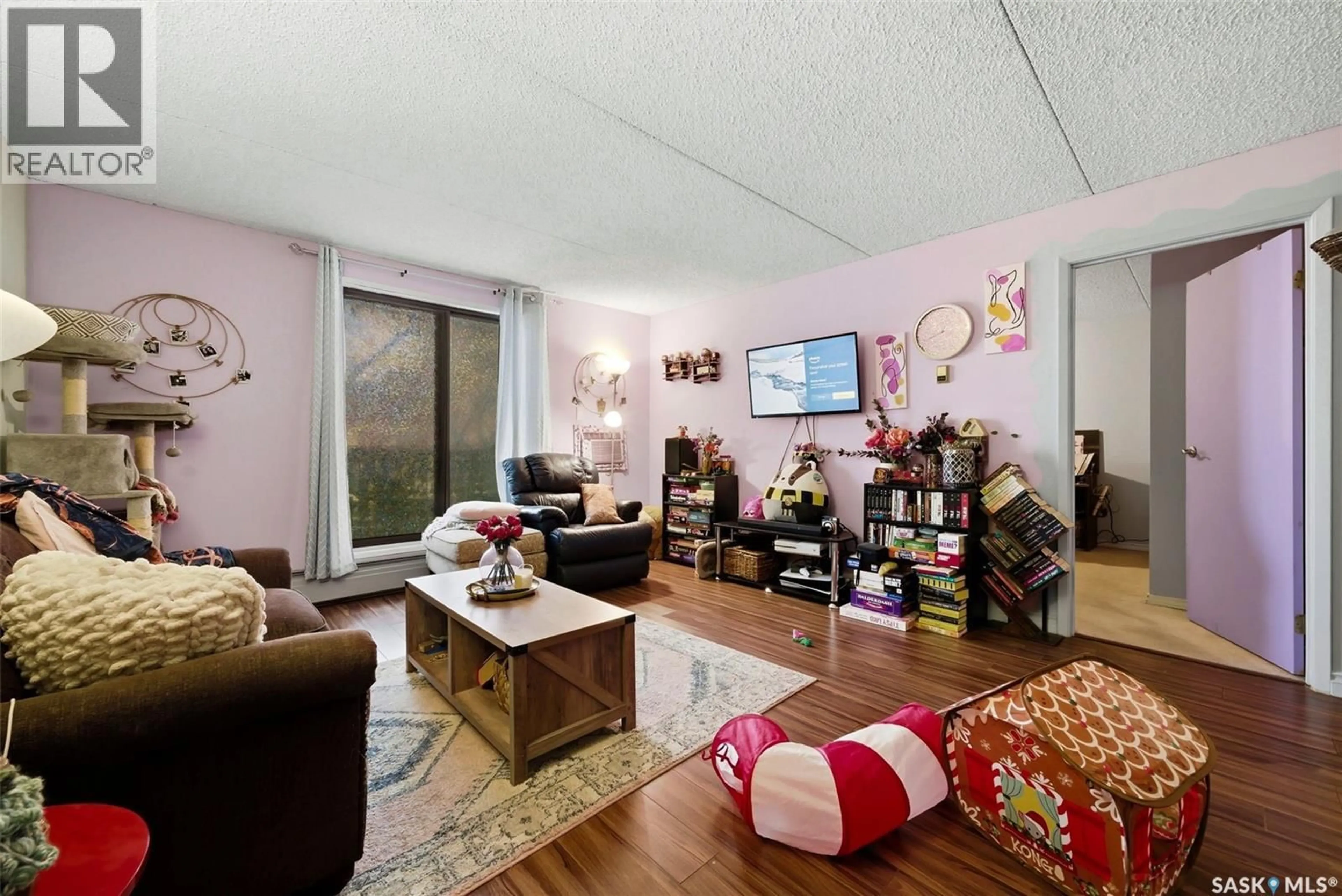 Living room with furniture, wood/laminate floor for 213 2125 OSLER STREET, Regina Saskatchewan S4P4G7