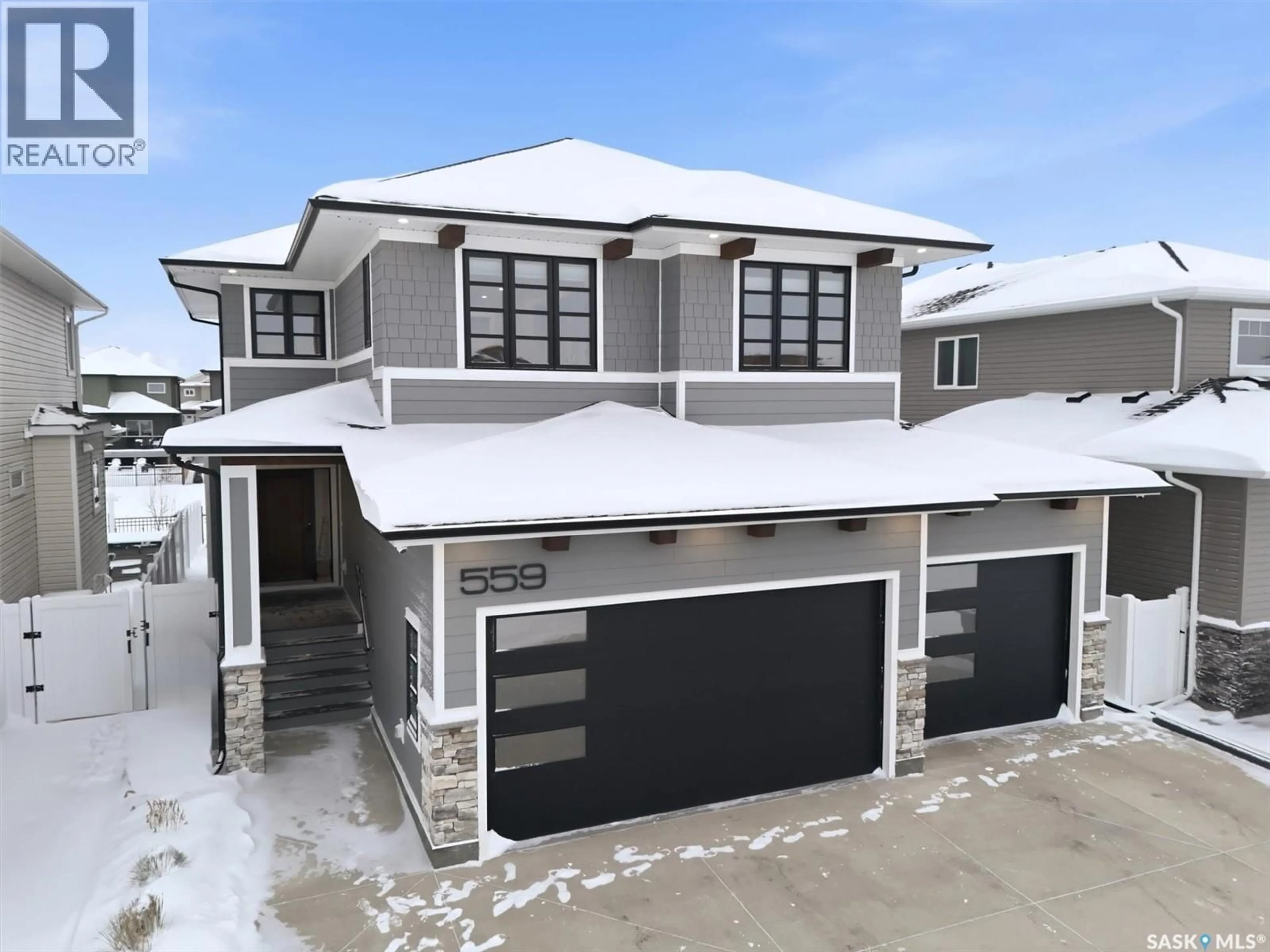 Home with vinyl exterior material, street for 559 BOLSTAD TURN, Saskatoon Saskatchewan S7W0C2