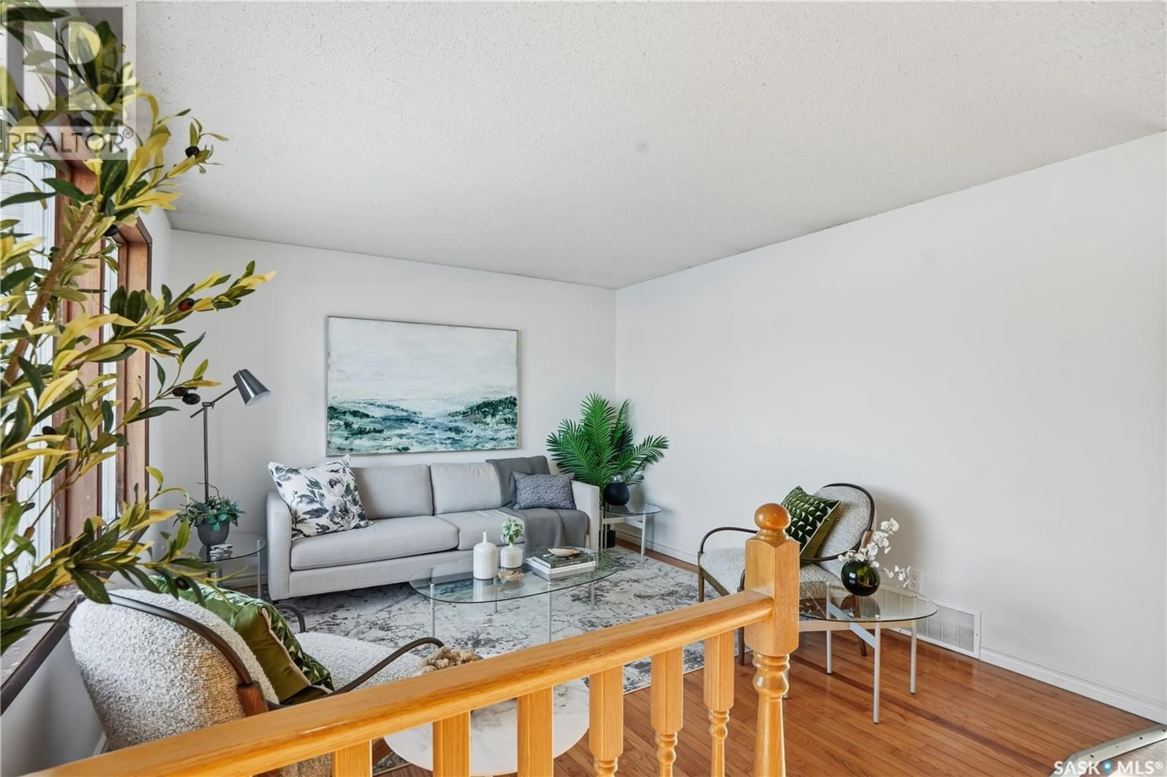 Living room with furniture, wood/laminate floor for 226 STILLWATER DRIVE, Saskatoon Saskatchewan S7J4K3