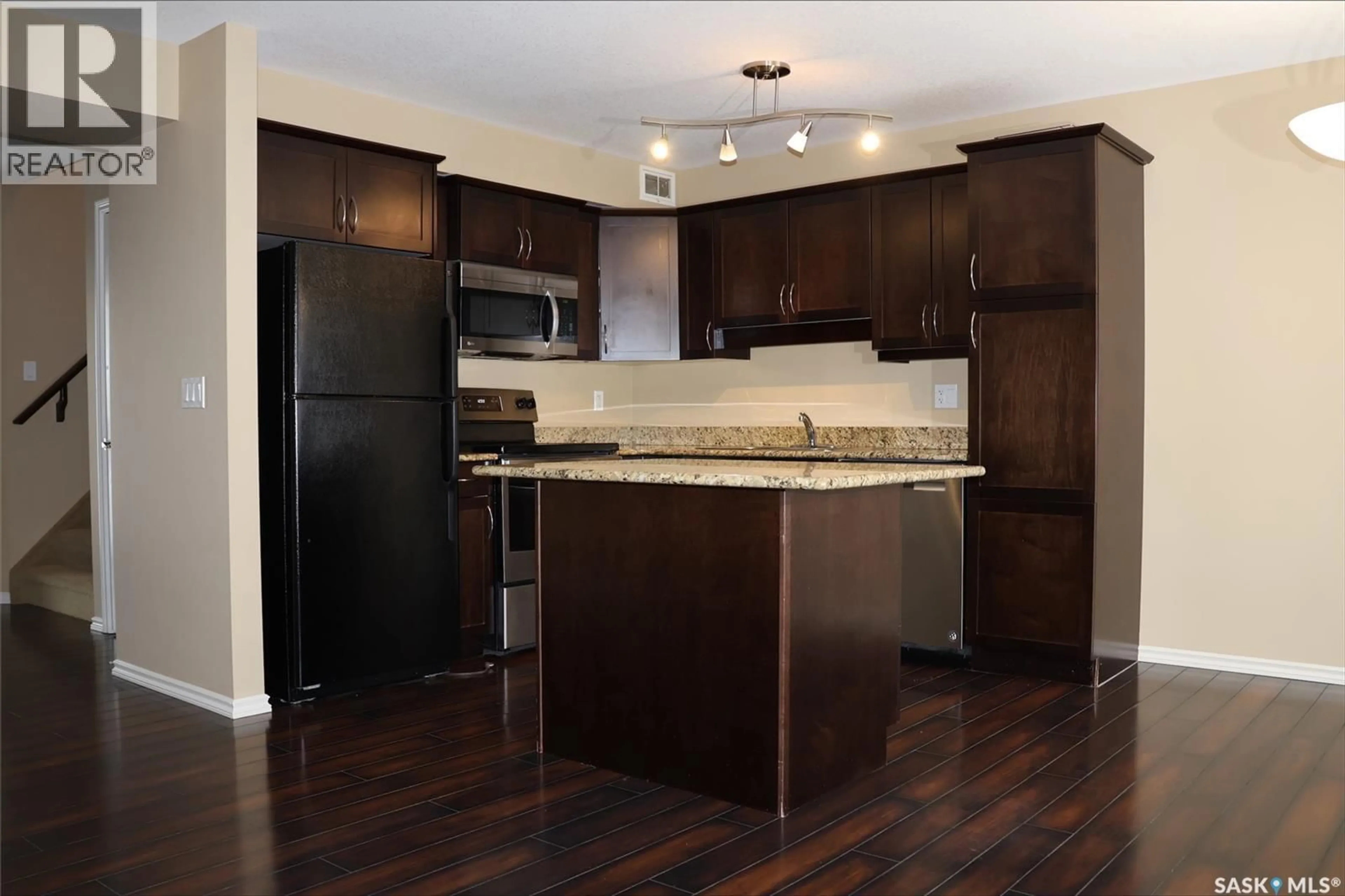 Open concept kitchen, wood/laminate floor for 410 615 LYND CRESCENT, Saskatoon Saskatchewan S7T0G8