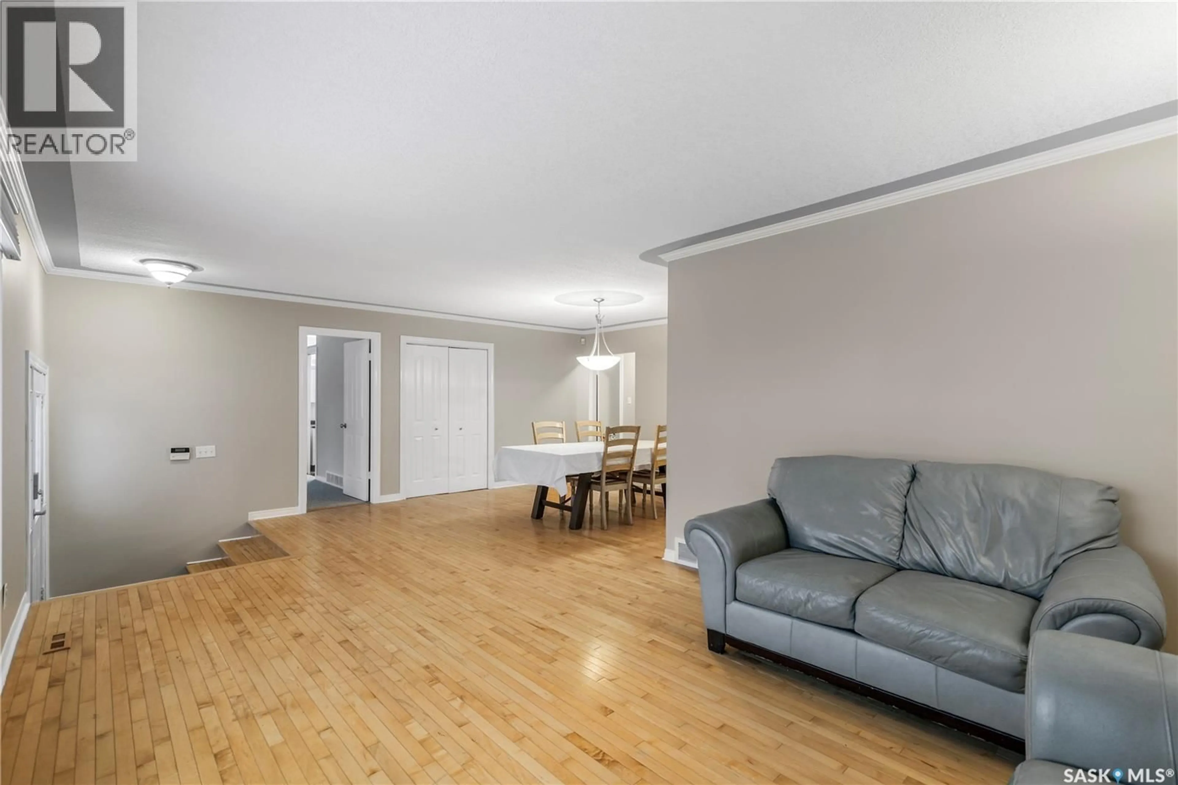 Living room with furniture, wood/laminate floor for 311 HABKIRK DRIVE, Regina Saskatchewan S4S6A9