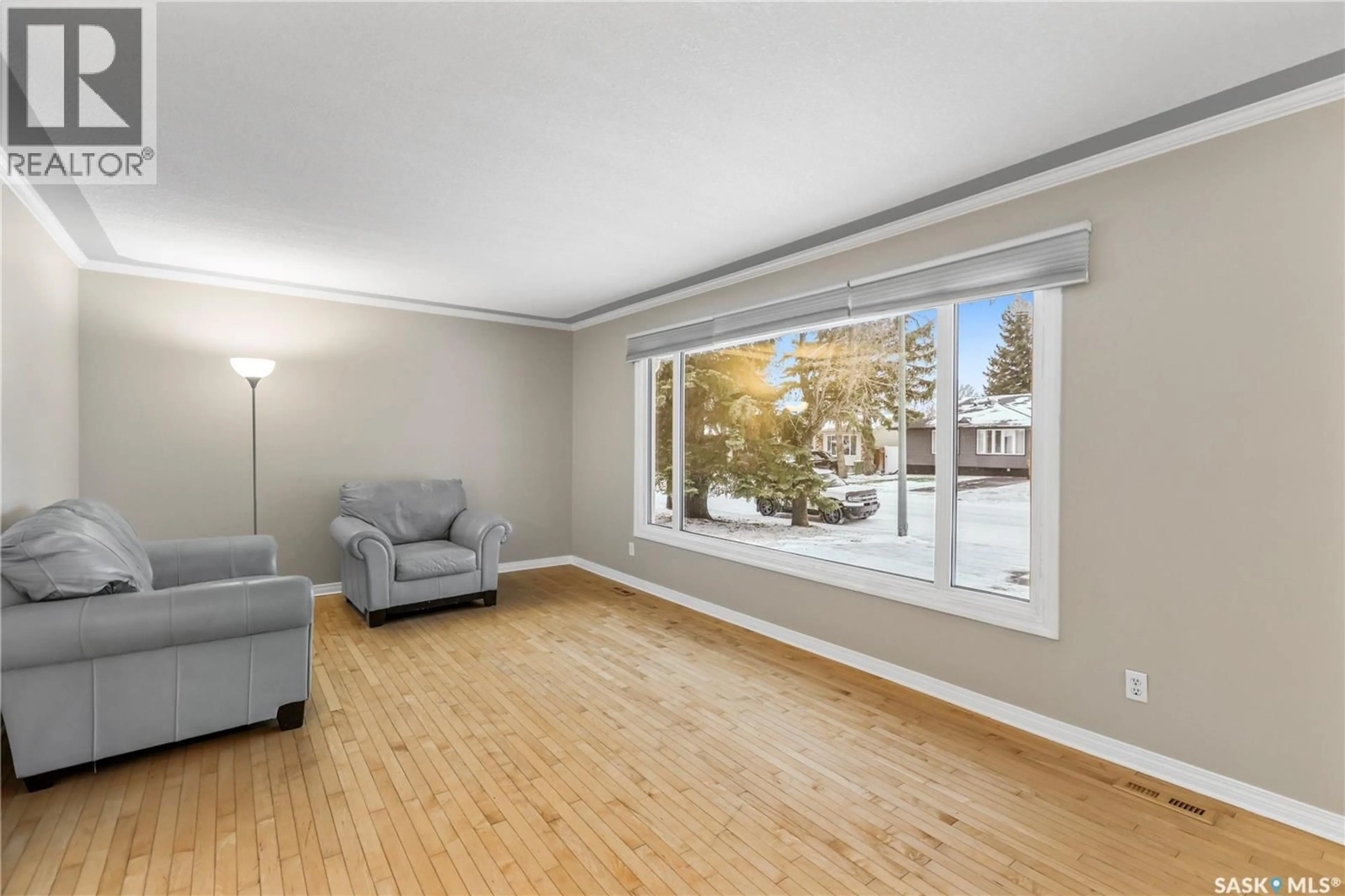 Living room with furniture, wood/laminate floor for 311 HABKIRK DRIVE, Regina Saskatchewan S4S6A9