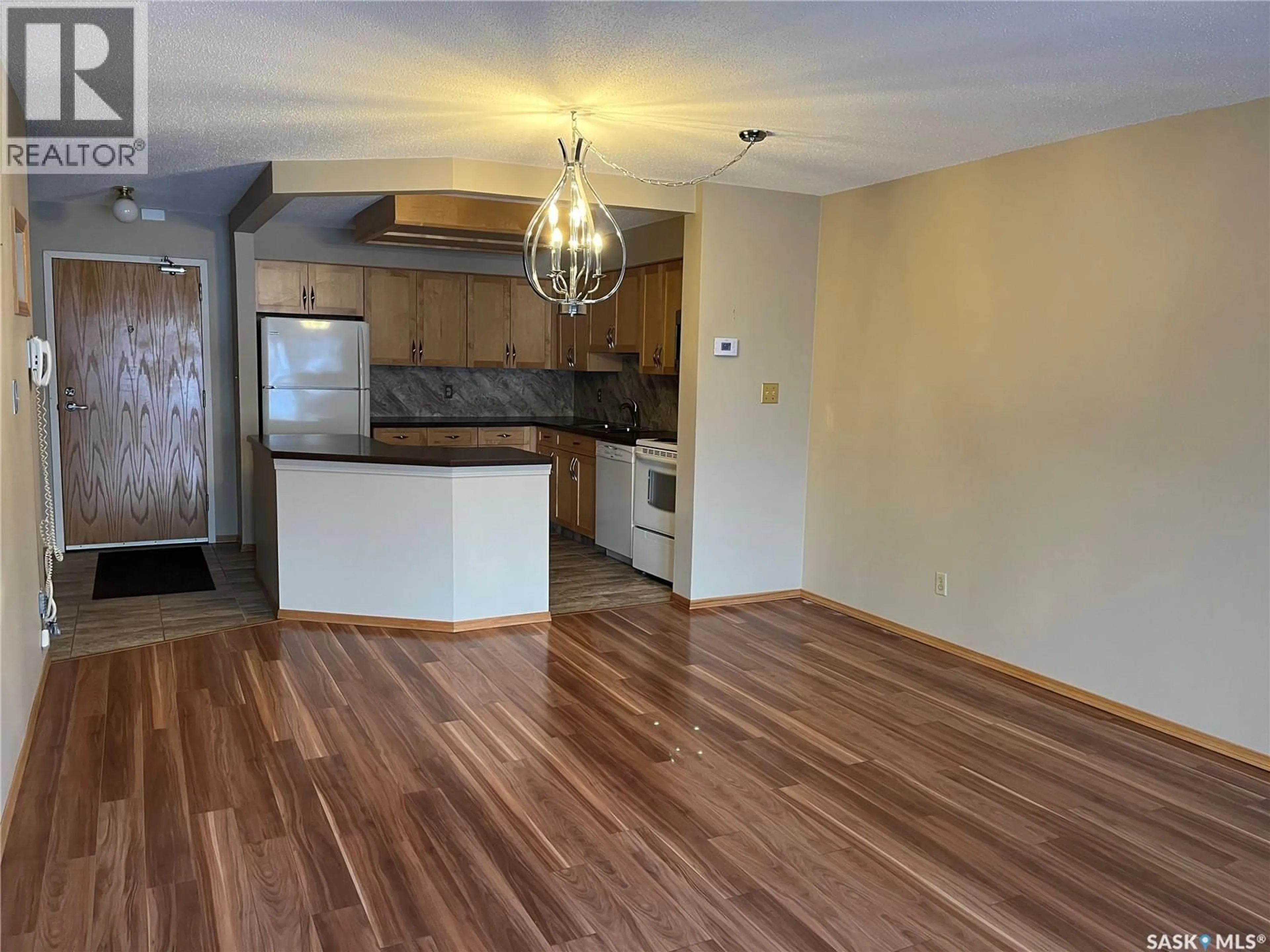 Open concept kitchen, wood/laminate floor for 239 908 ASSINIBOINE AVENUE E, Regina Saskatchewan S4V2P8
