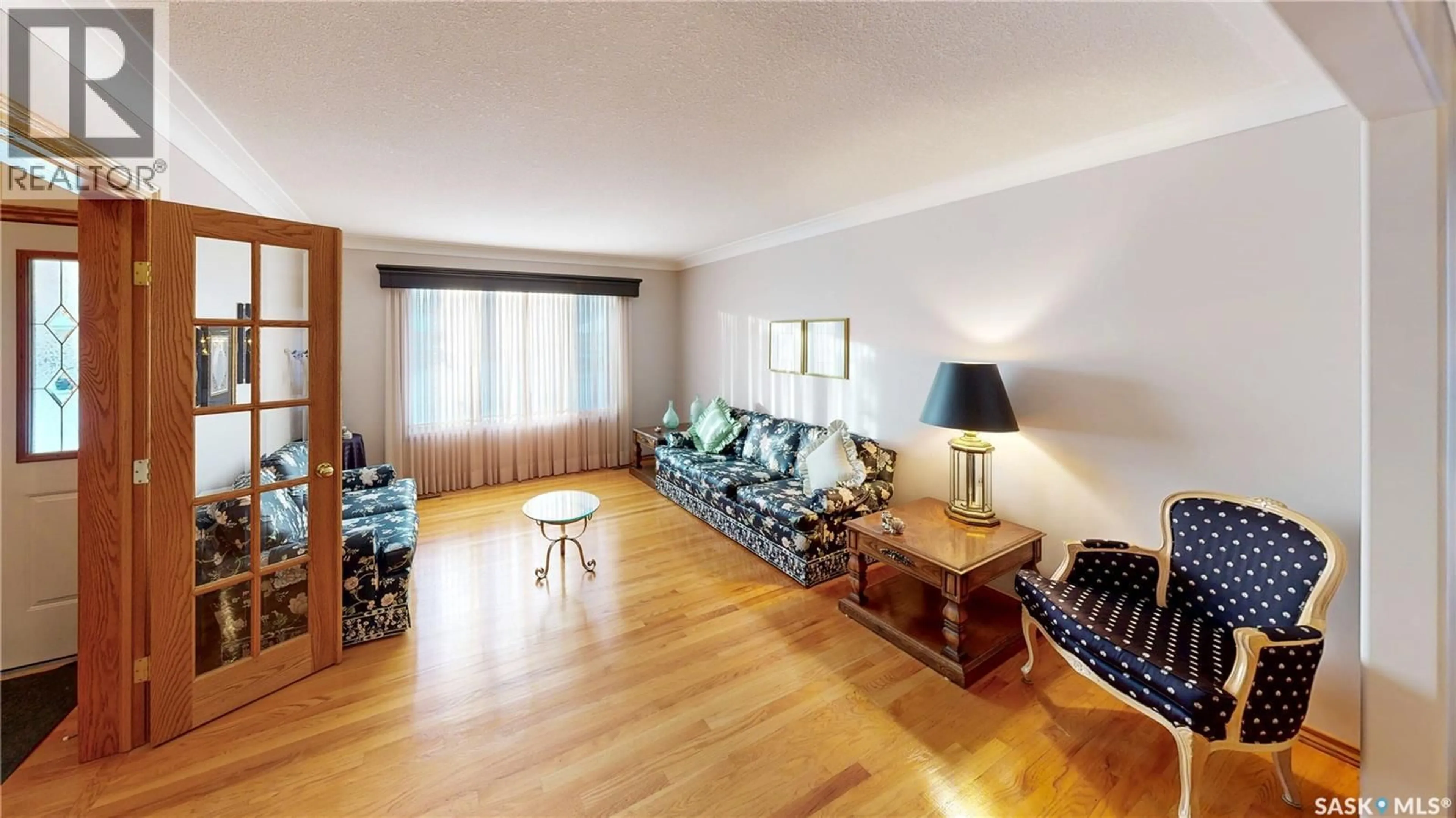 Living room with furniture, wood/laminate floor for 2114 WASCANA GREENS, Regina Saskatchewan S4V2K9