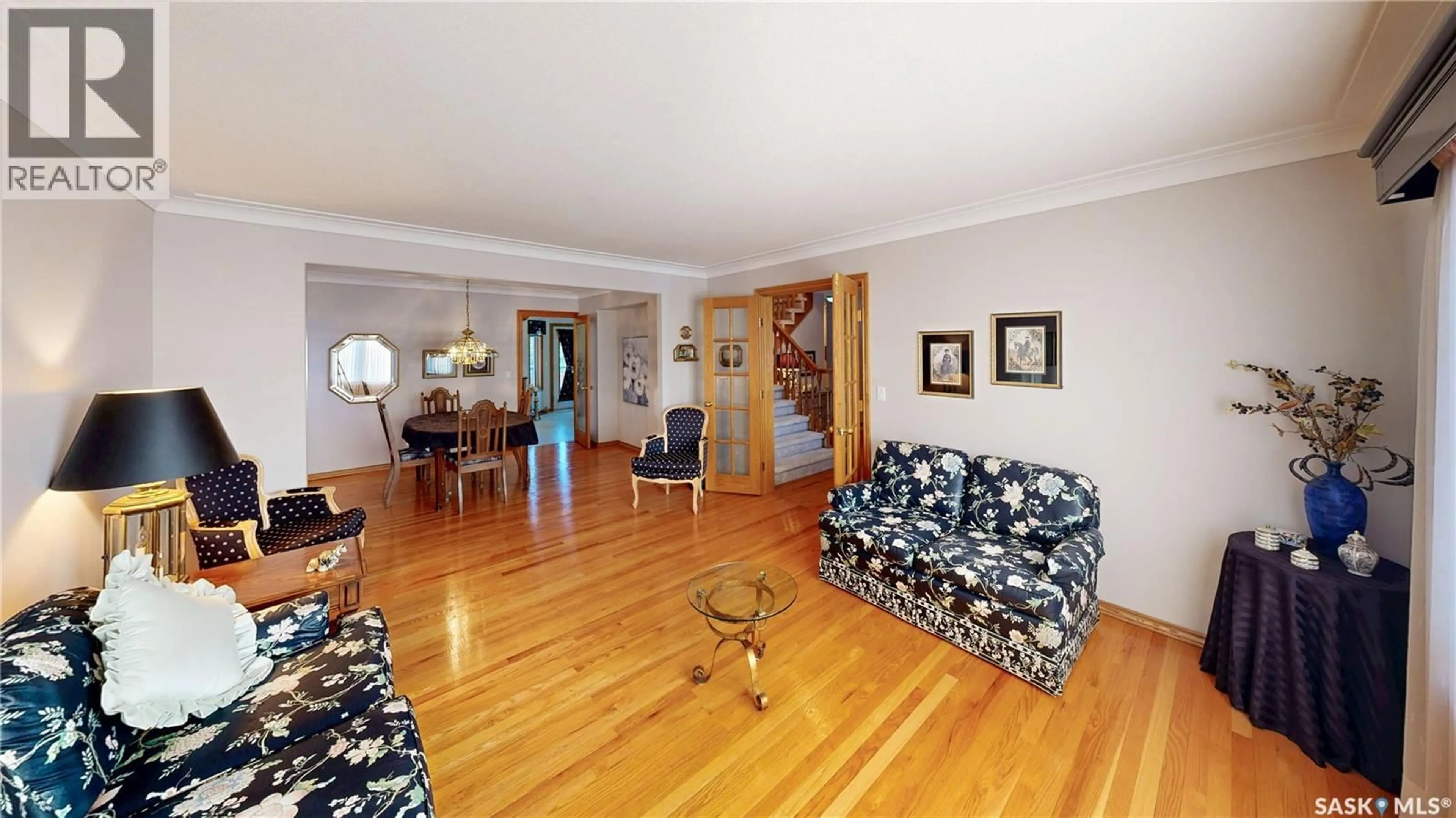 Living room with furniture, wood/laminate floor for 2114 WASCANA GREENS, Regina Saskatchewan S4V2K9