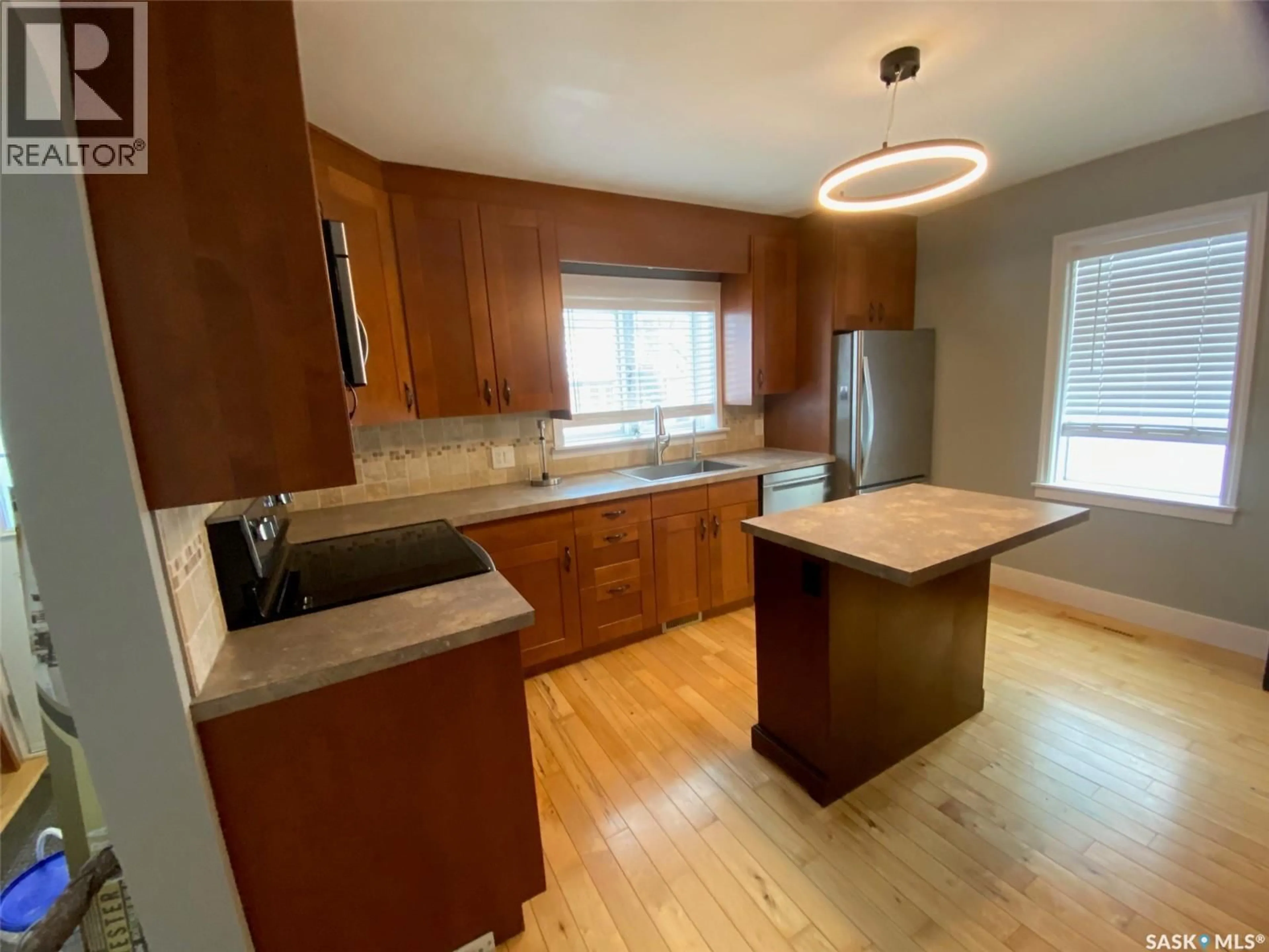 Open concept kitchen, wood/laminate floor for 100 THIRD AVENUE, Yorkton Saskatchewan S3N1C3