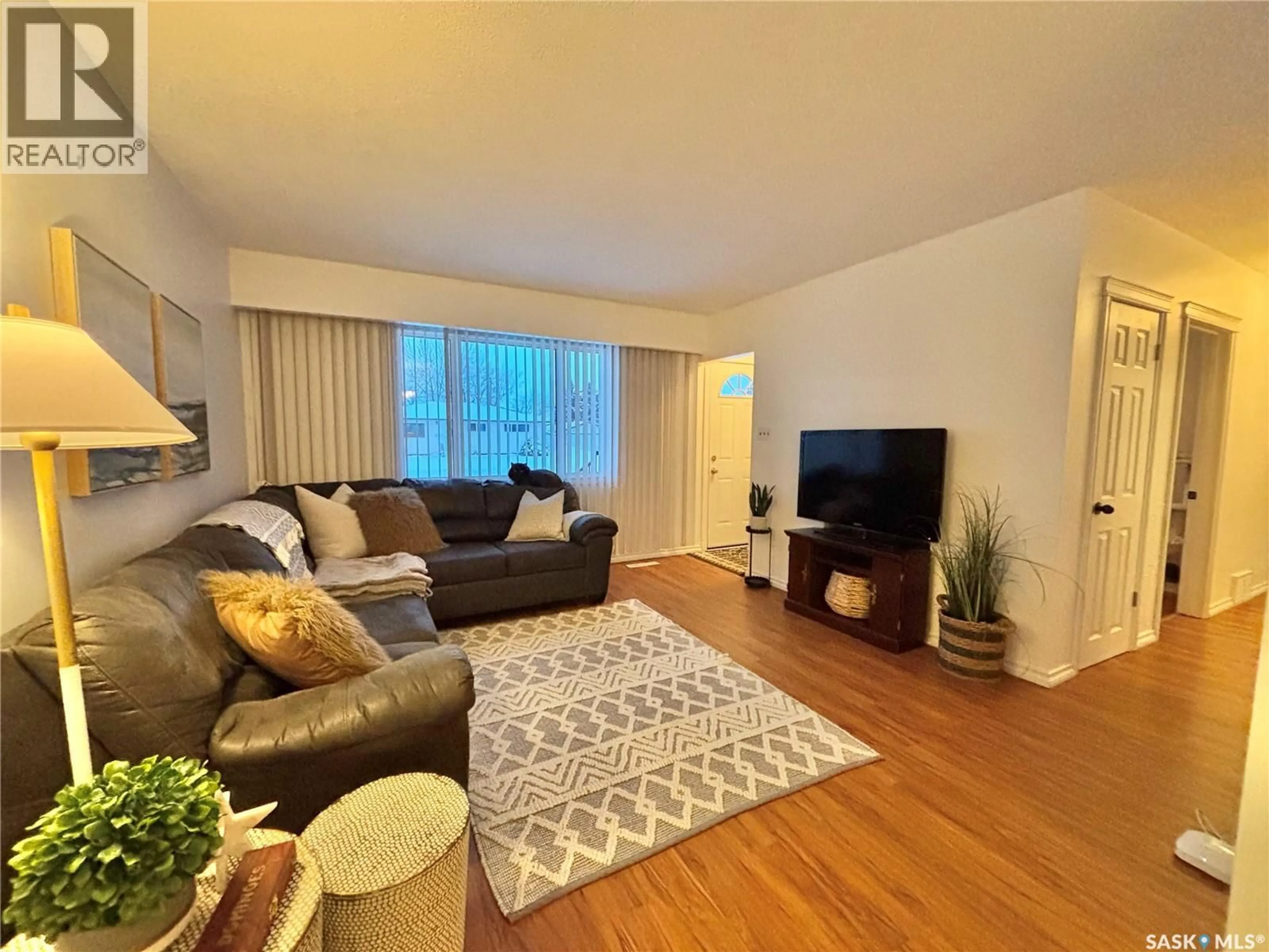 Living room with furniture, wood/laminate floor for 53 BAILEY DRIVE, Yorkton Saskatchewan S3N2J2