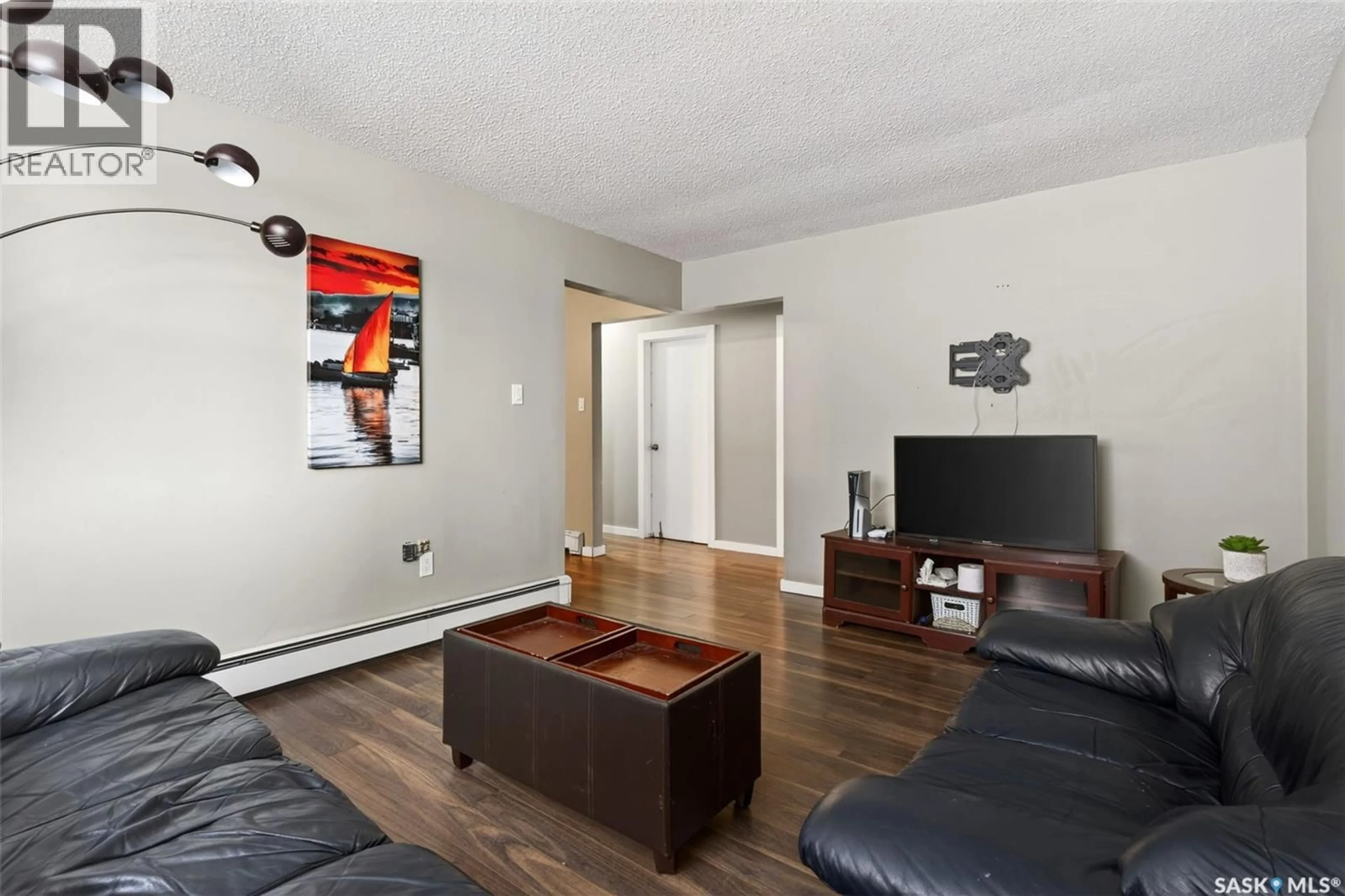 Living room with furniture, wood/laminate floor for 14 125 FROOM CRESCENT, Regina Saskatchewan S4N1S8