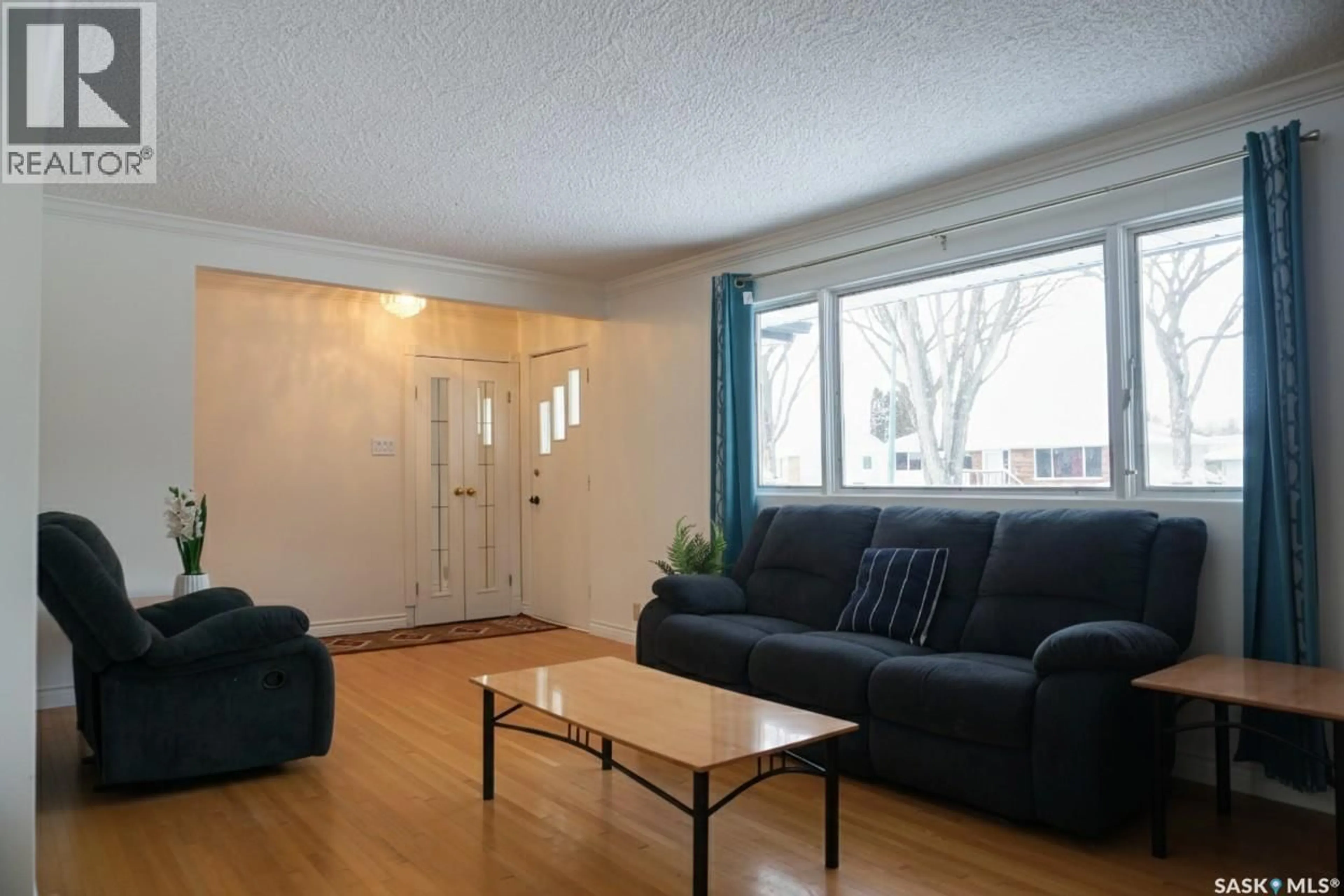 Living room with furniture, wood/laminate floor for 81 MCNAB CRESCENT, Regina Saskatchewan S4S4B3