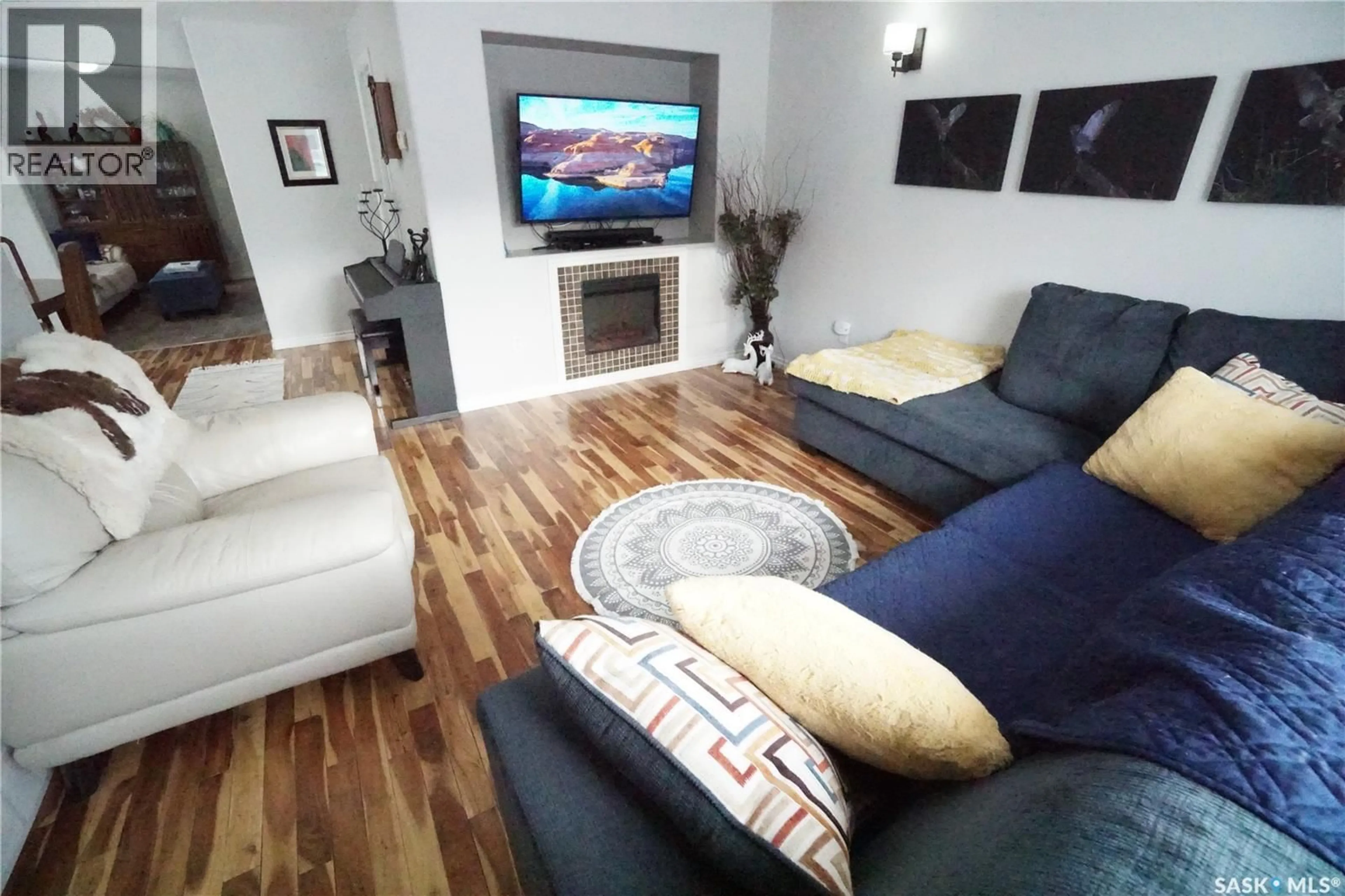 Living room with furniture, wood/laminate floor for 234 LILLOOET STREET, Moose Jaw Saskatchewan S6H4Z3