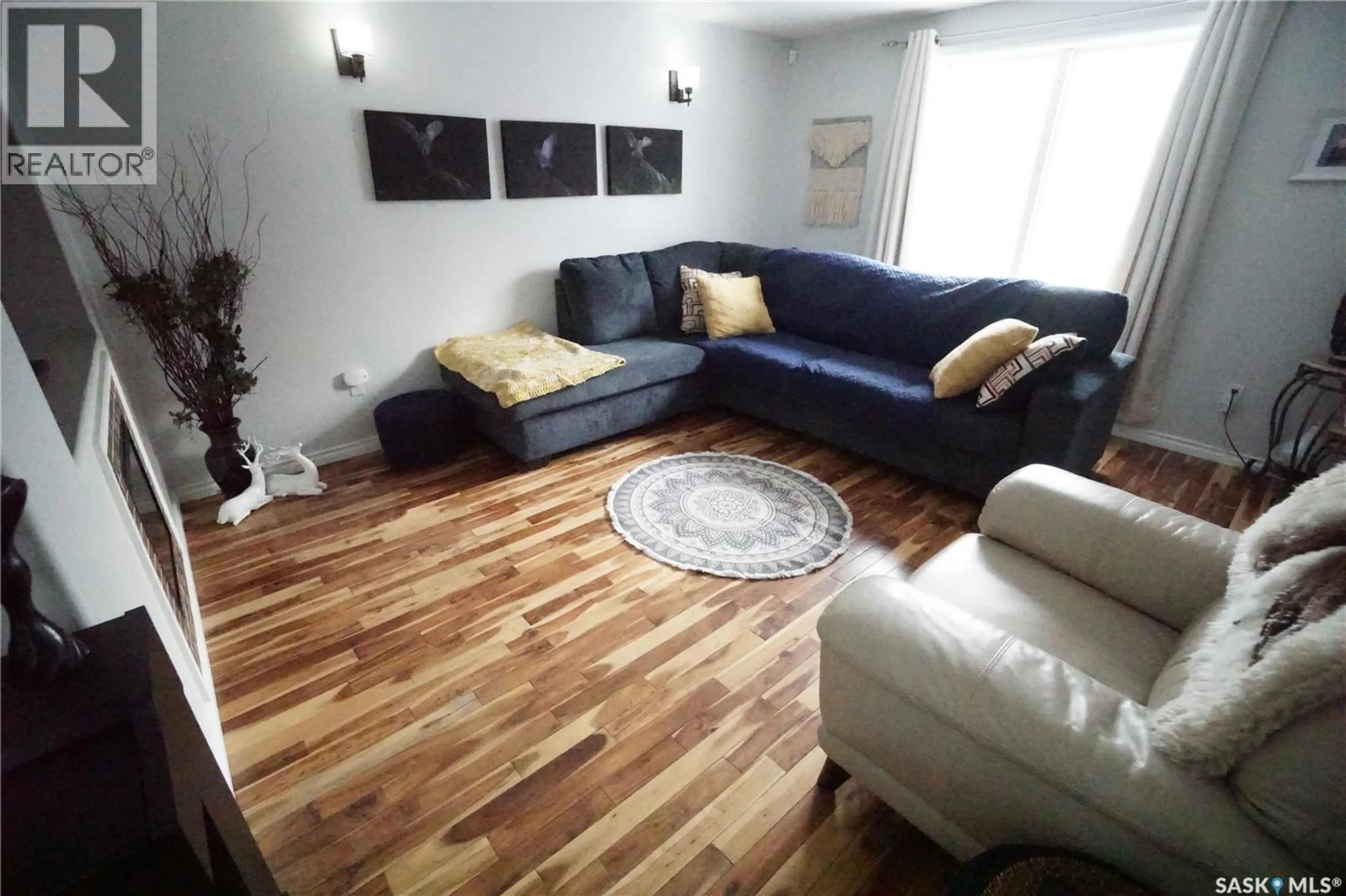 Living room with furniture, wood/laminate floor for 234 LILLOOET STREET, Moose Jaw Saskatchewan S6H4Z3