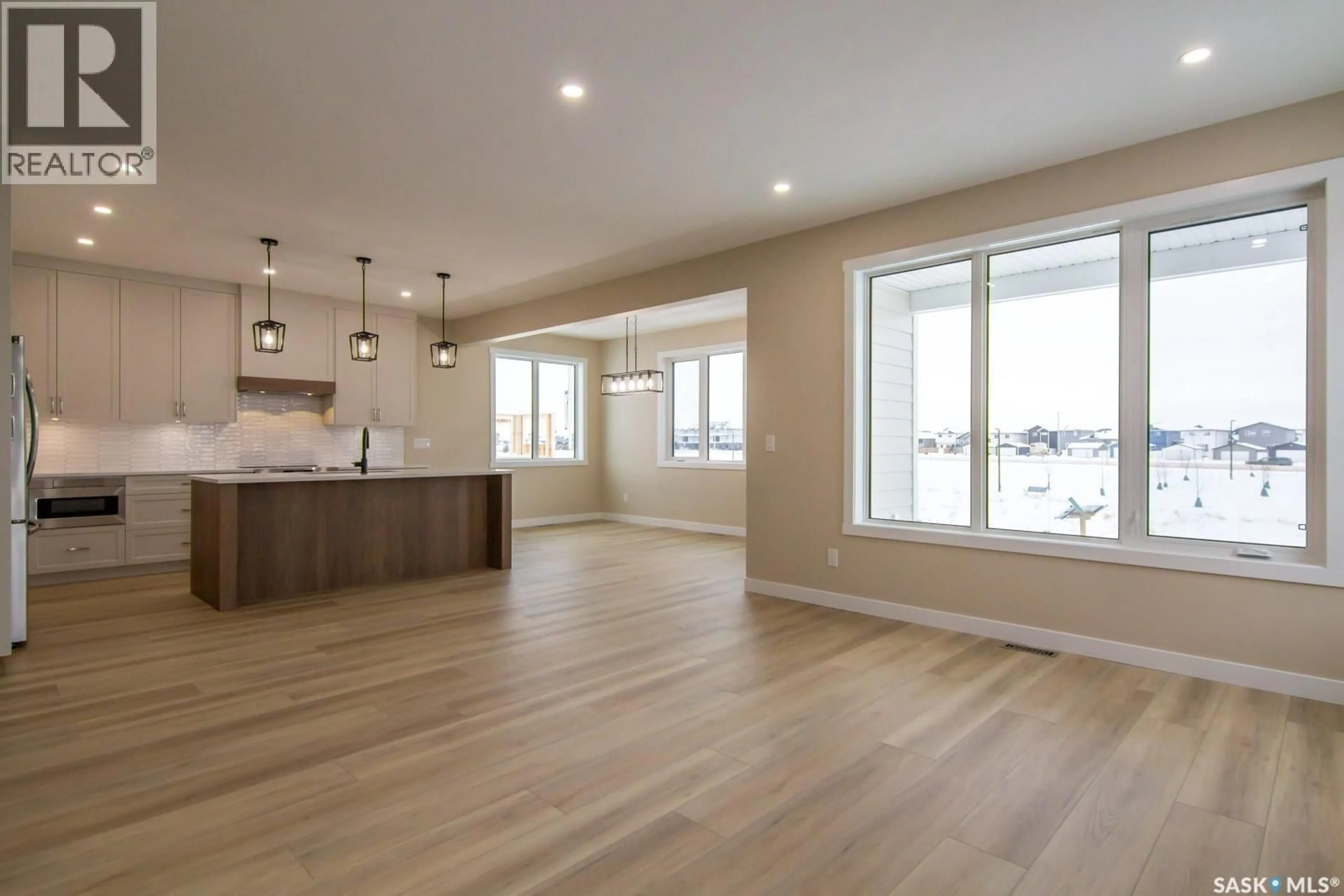 Open concept kitchen, wood/laminate floor for 435 SHARMA CRESCENT, Saskatoon Saskatchewan S7W0Y4
