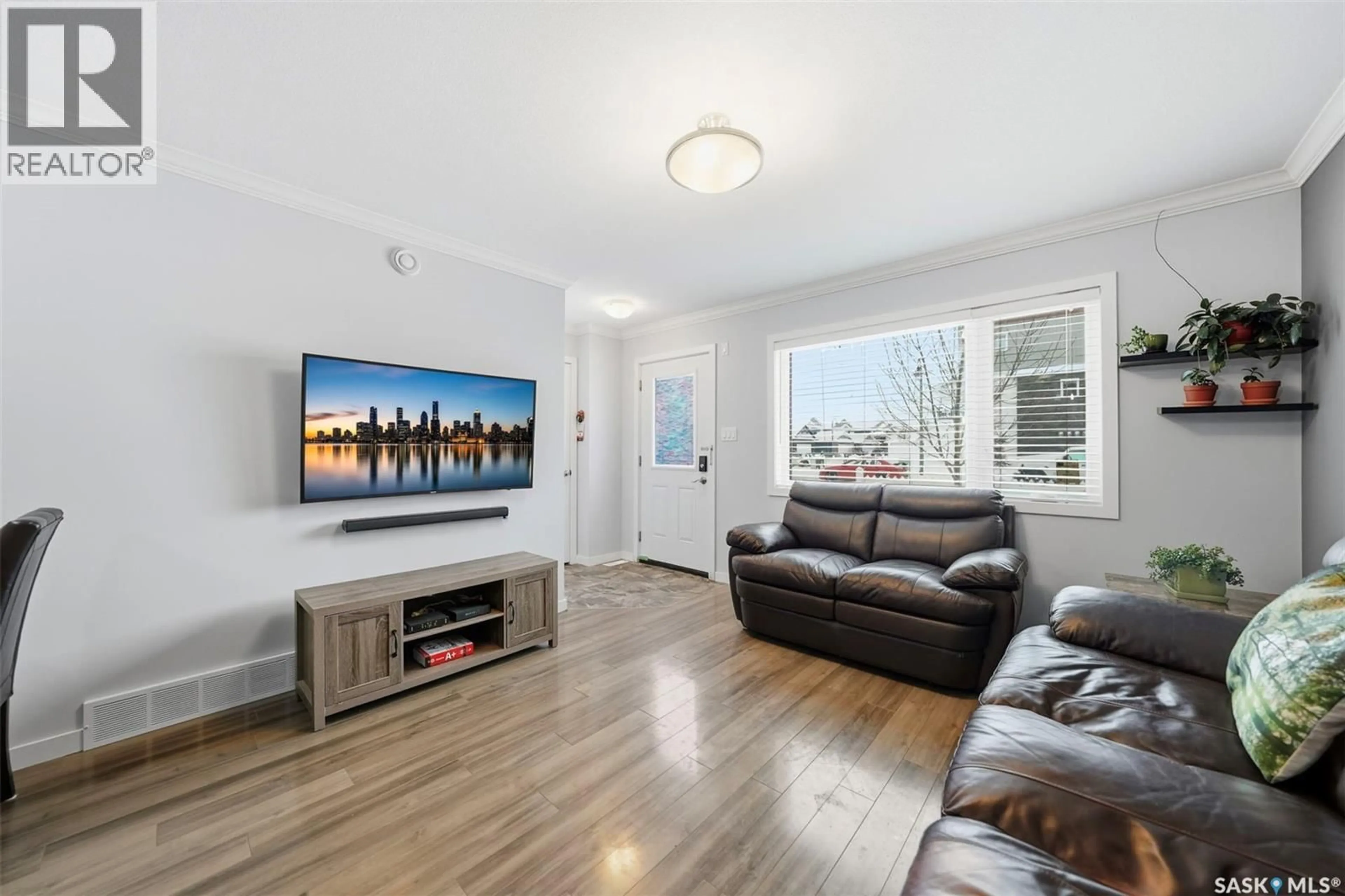 Living room with furniture, wood/laminate floor for 320 - 329 CORNISH ROAD, Saskatoon Saskatchewan S7T0Y3