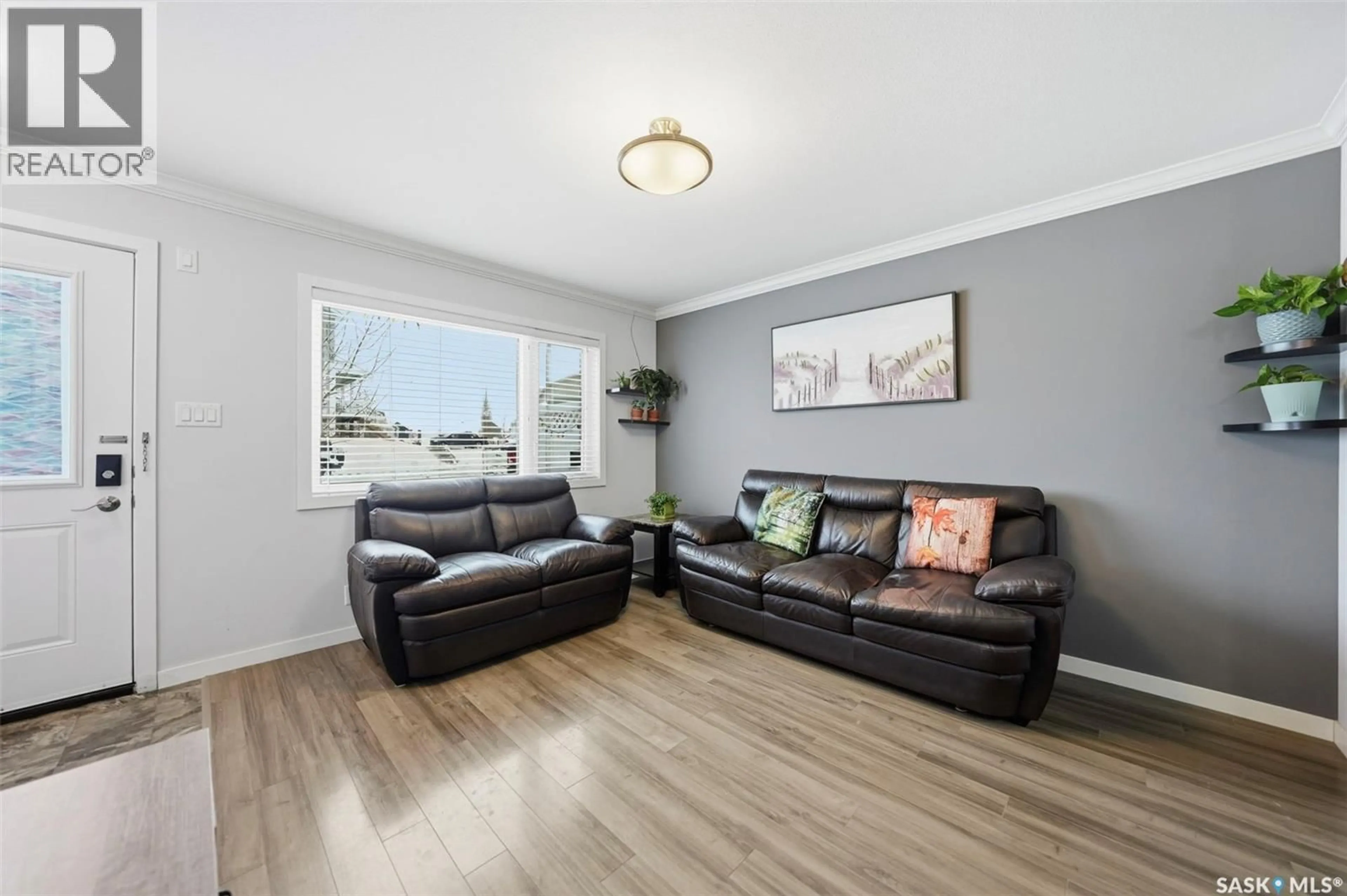 Living room with furniture, wood/laminate floor for 320 - 329 CORNISH ROAD, Saskatoon Saskatchewan S7T0Y3