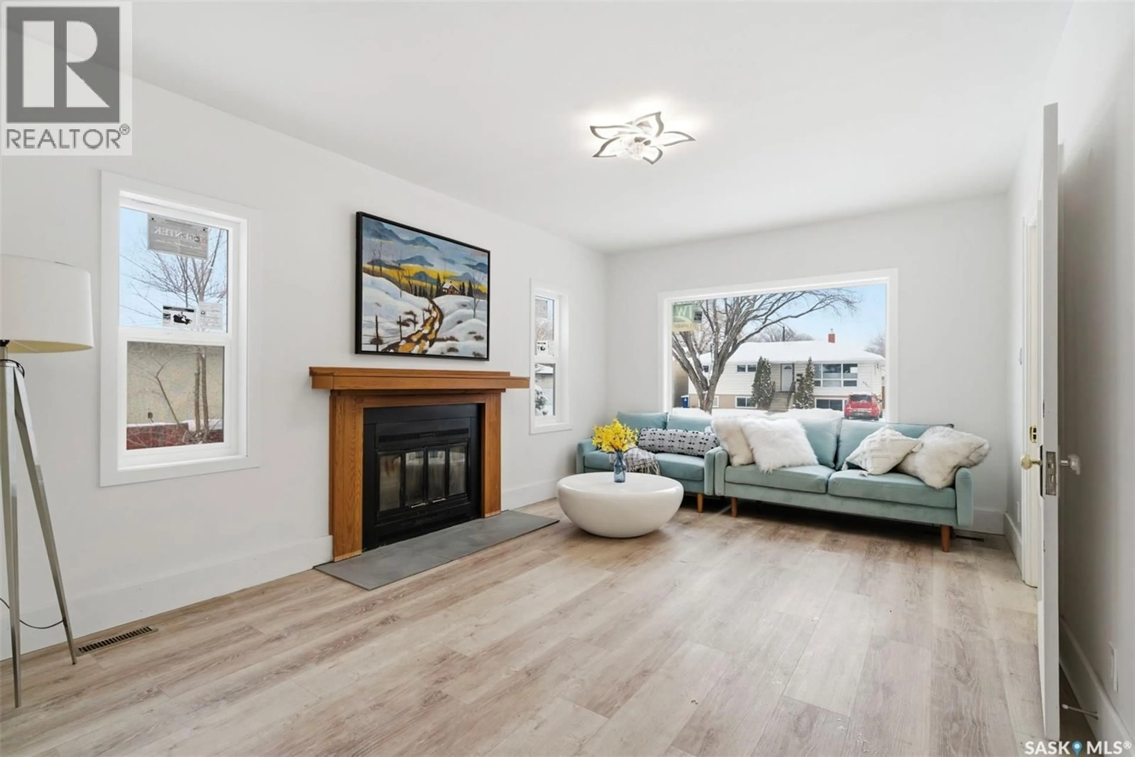 Living room with furniture, wood/laminate floor for 1709 E AVENUE N, Saskatoon Saskatchewan S7L1V3