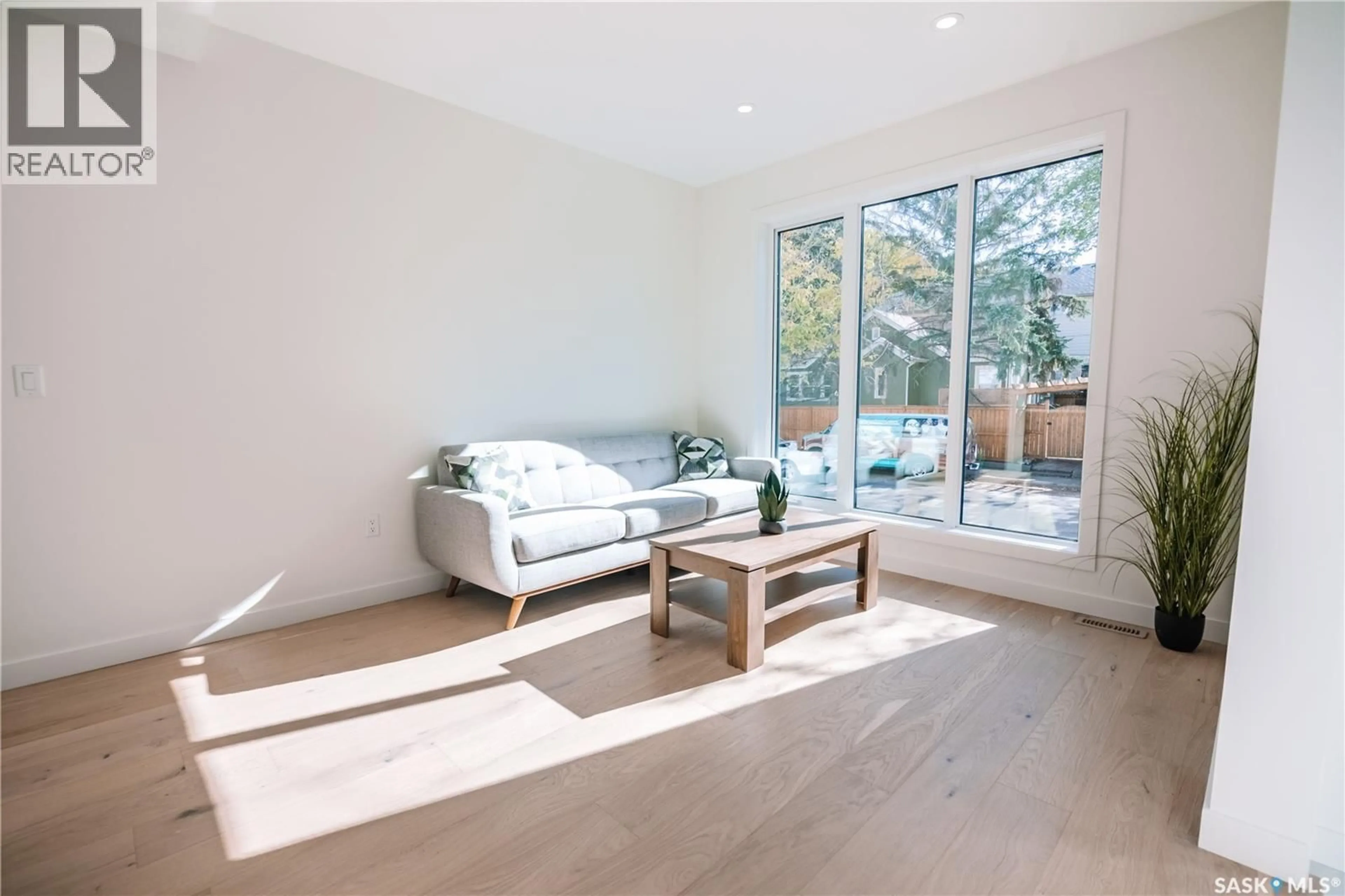 Living room with furniture, wood/laminate floor for 2804 14TH AVENUE, Regina Saskatchewan S4T5S8