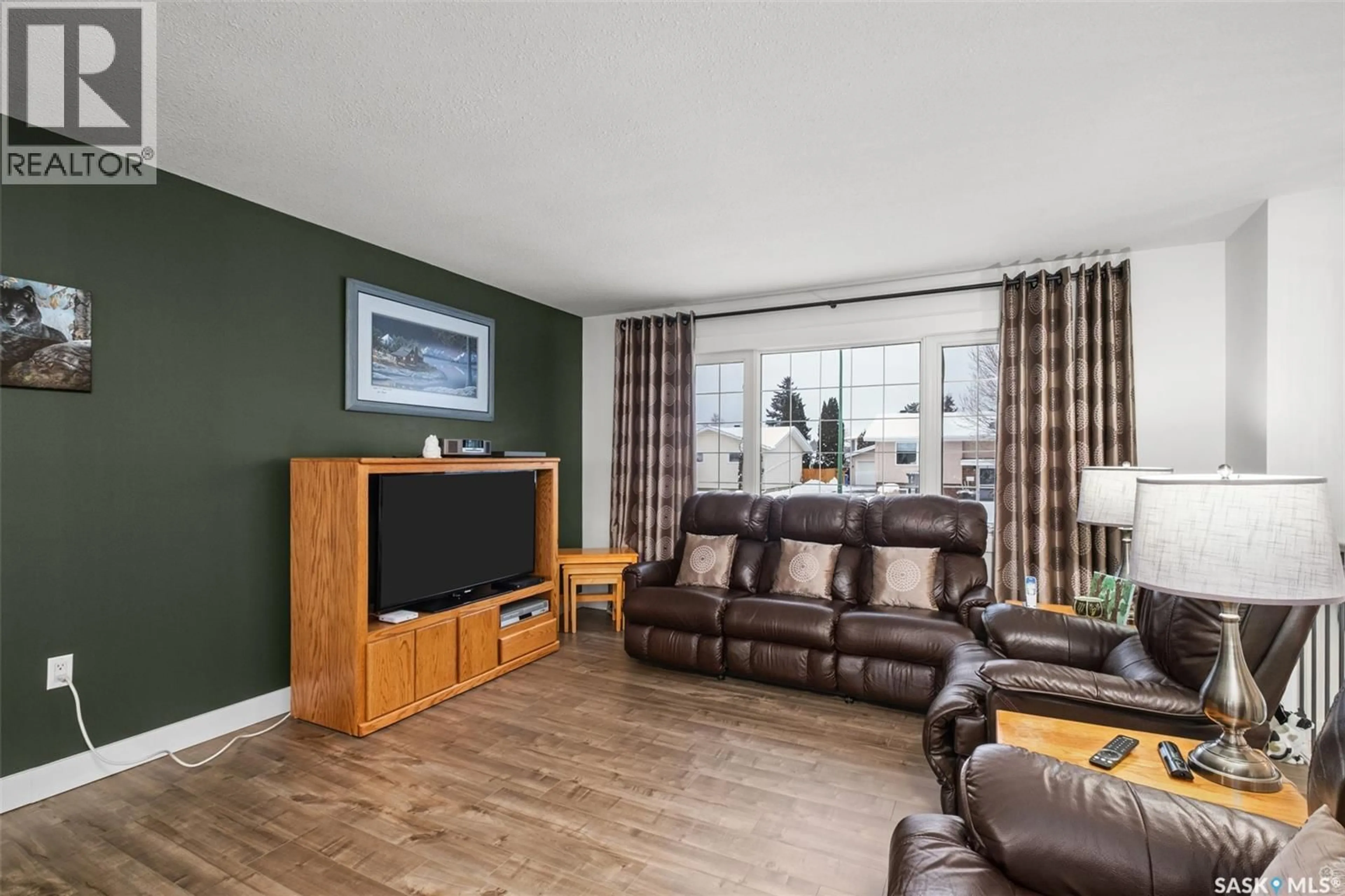 Living room with furniture, wood/laminate floor for 975 SANDERSON CRESCENT, Prince Albert Saskatchewan S6V6L2