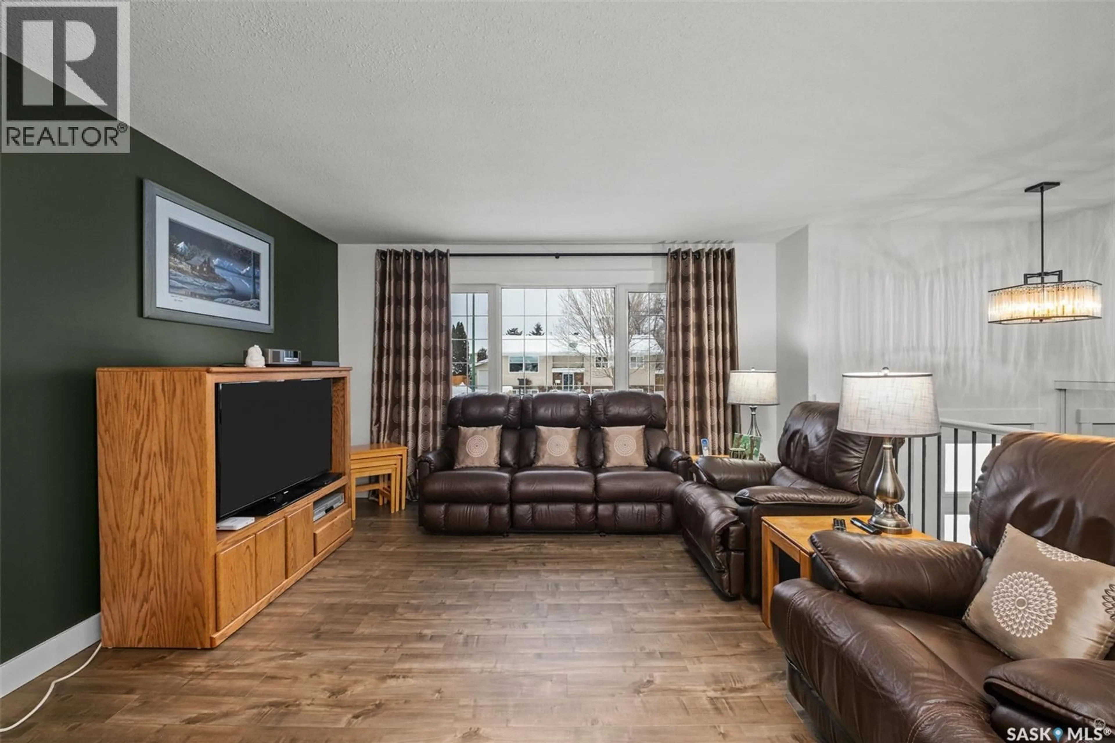 Living room with furniture, wood/laminate floor for 975 SANDERSON CRESCENT, Prince Albert Saskatchewan S6V6L2