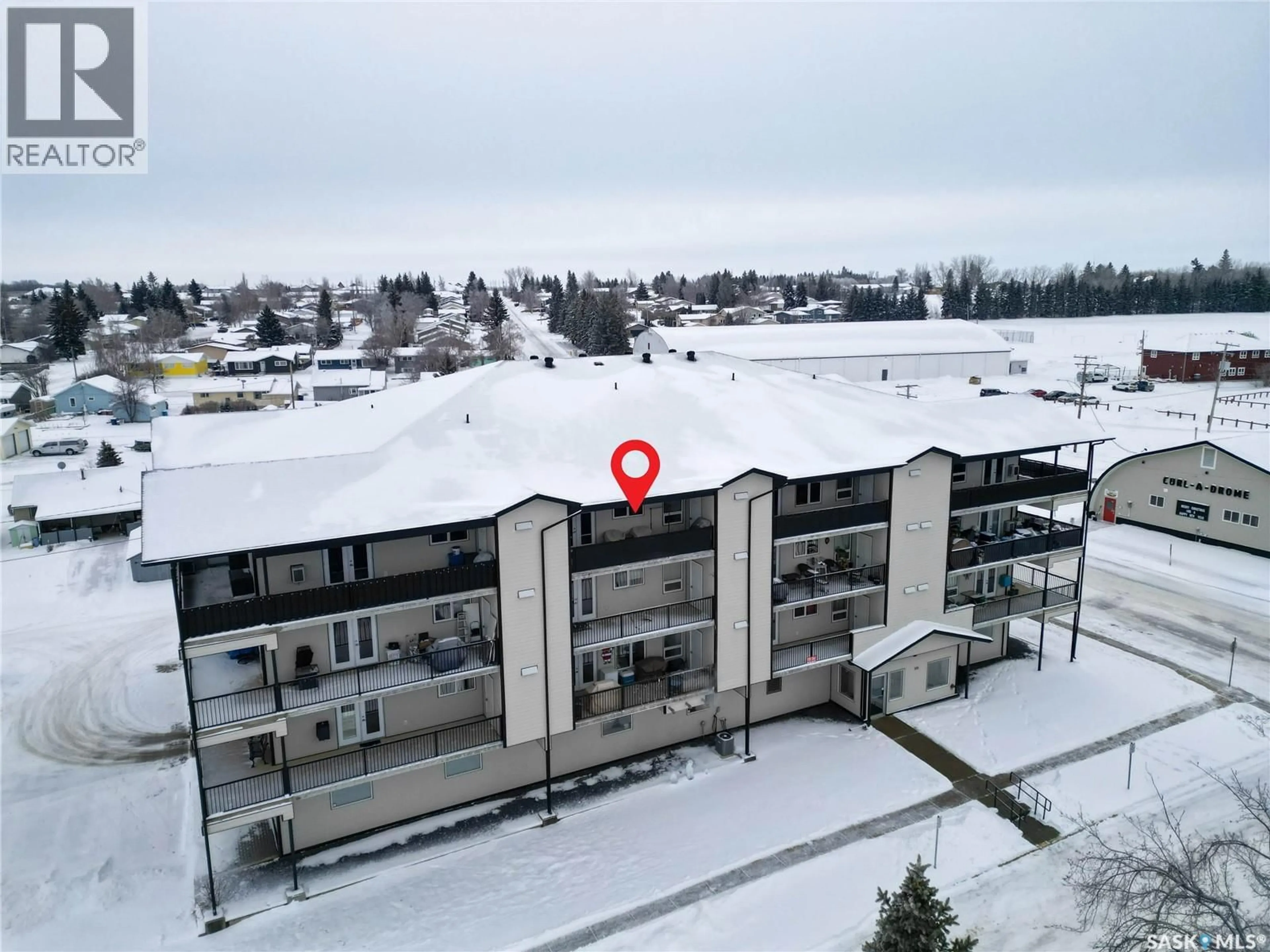 A pic from outside/outdoor area/front of a property/back of a property/a pic from drone, building for 201 220 MCCALLUM AVENUE, Birch Hills Saskatchewan S0J0G0