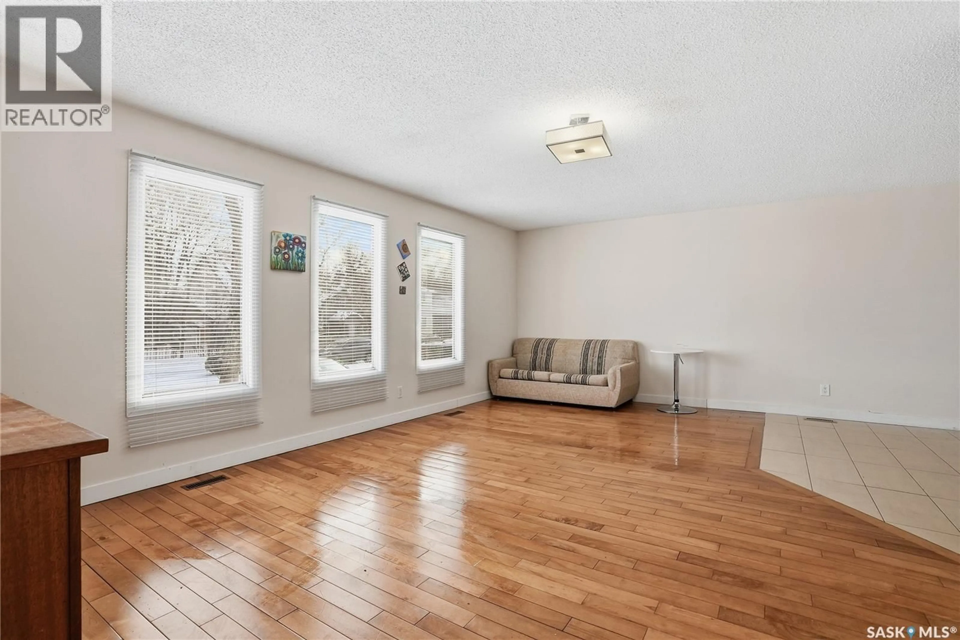 Living room with furniture, wood/laminate floor for 313 Q AVENUE, Saskatoon Saskatchewan S7M2Y2