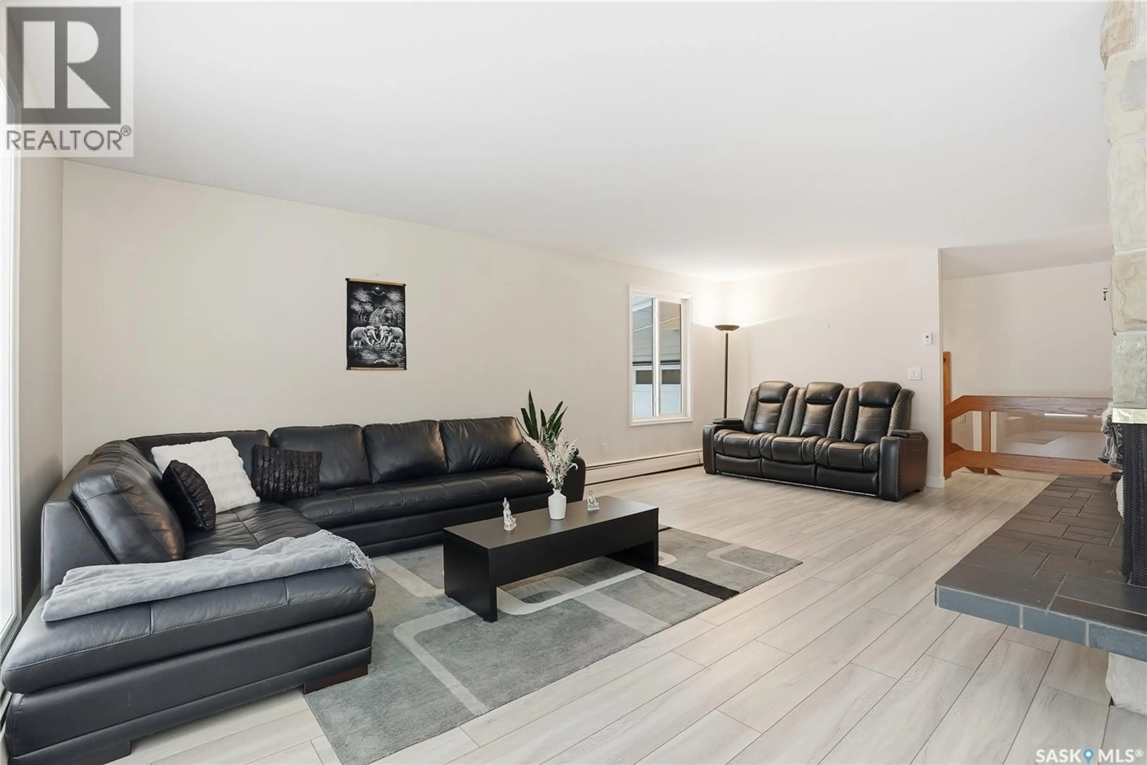 Living room with furniture, wood/laminate floor for 257 CAMPION CRESCENT, Saskatoon Saskatchewan S7H3T8