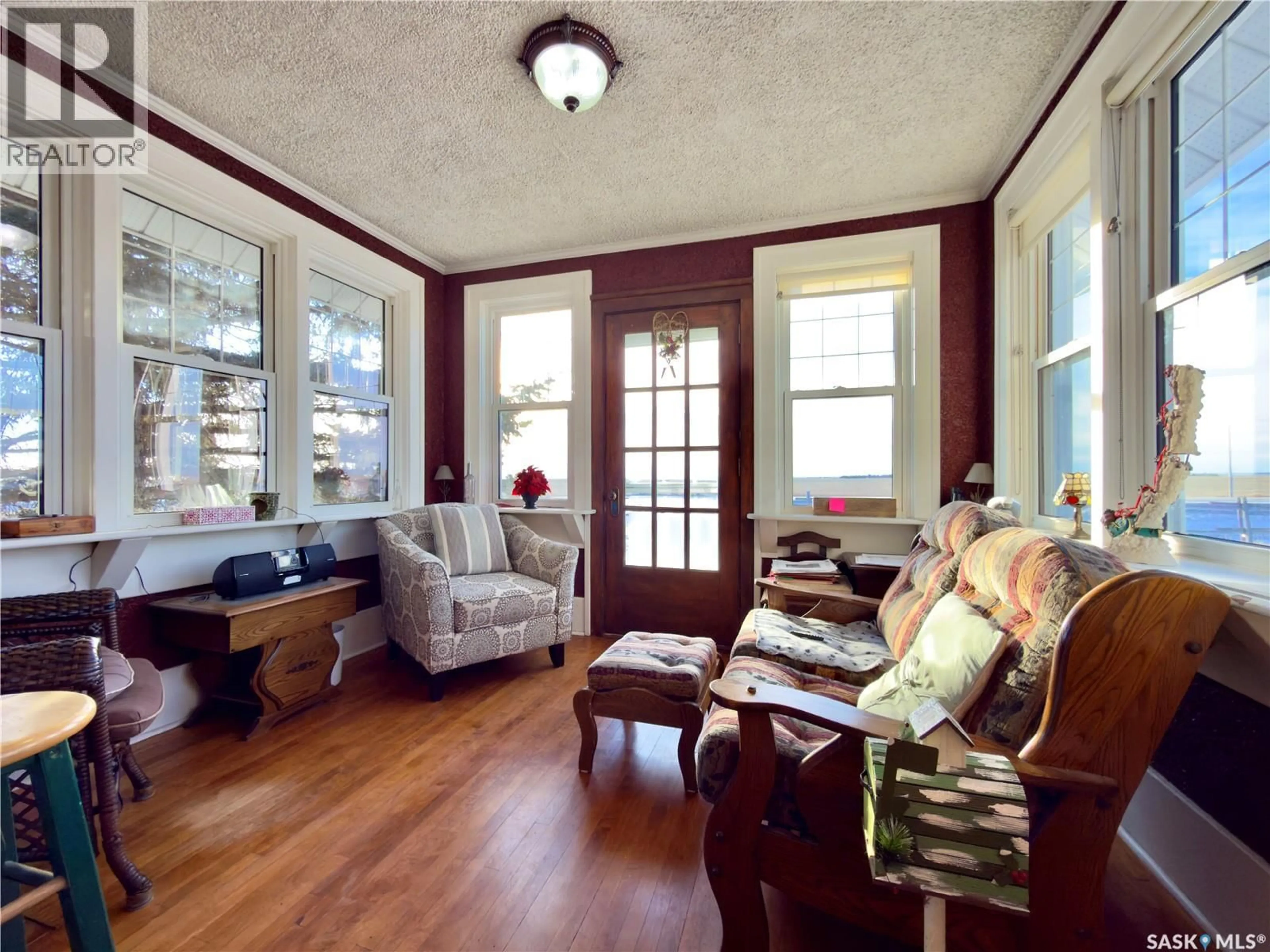 Living room with furniture, wood/laminate floor for SUTTON ACREAGE, Sutton Rm No. 103 Saskatchewan S0H1X0