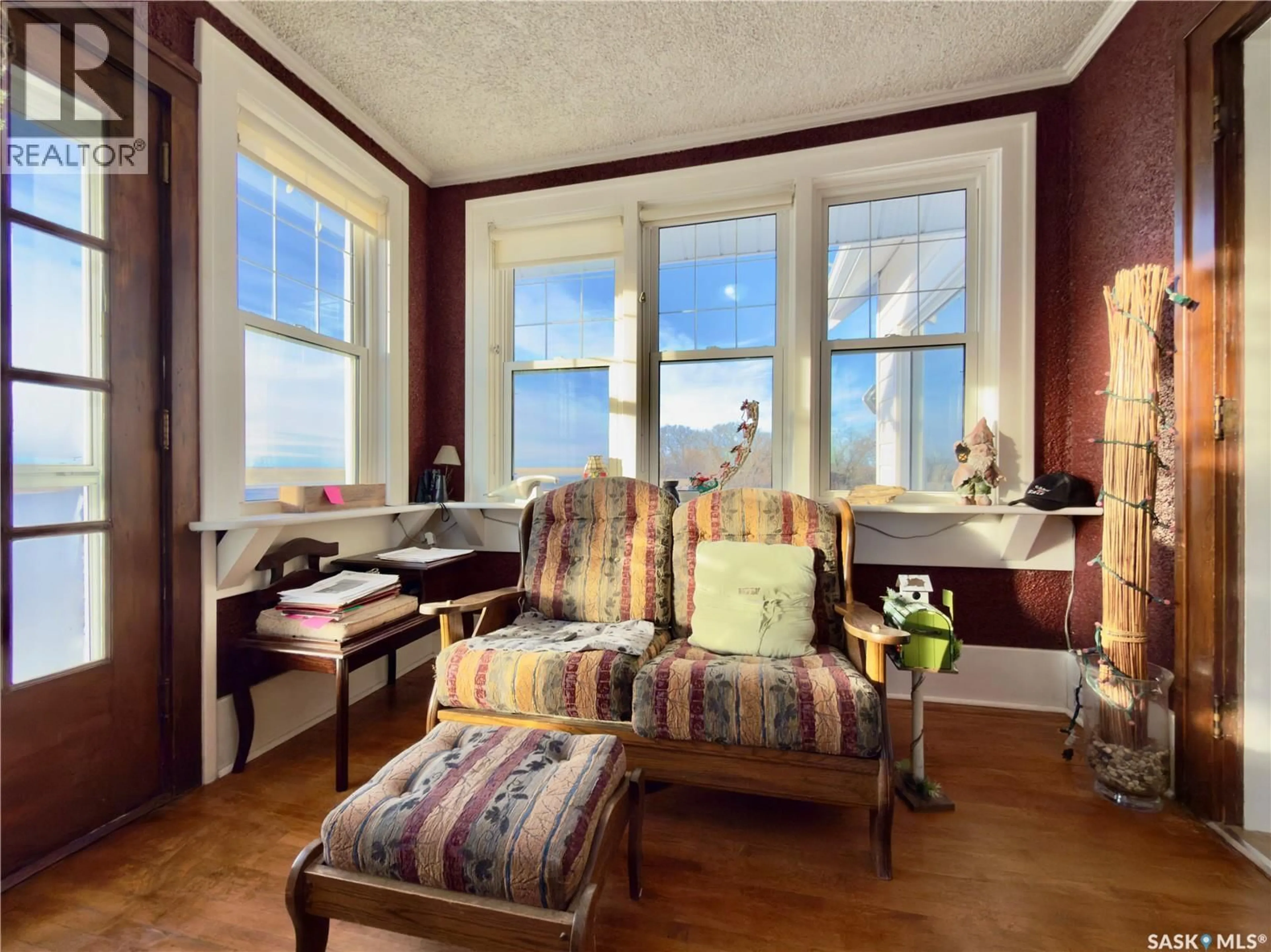 Living room with furniture, wood/laminate floor for SUTTON ACREAGE, Sutton Rm No. 103 Saskatchewan S0H1X0