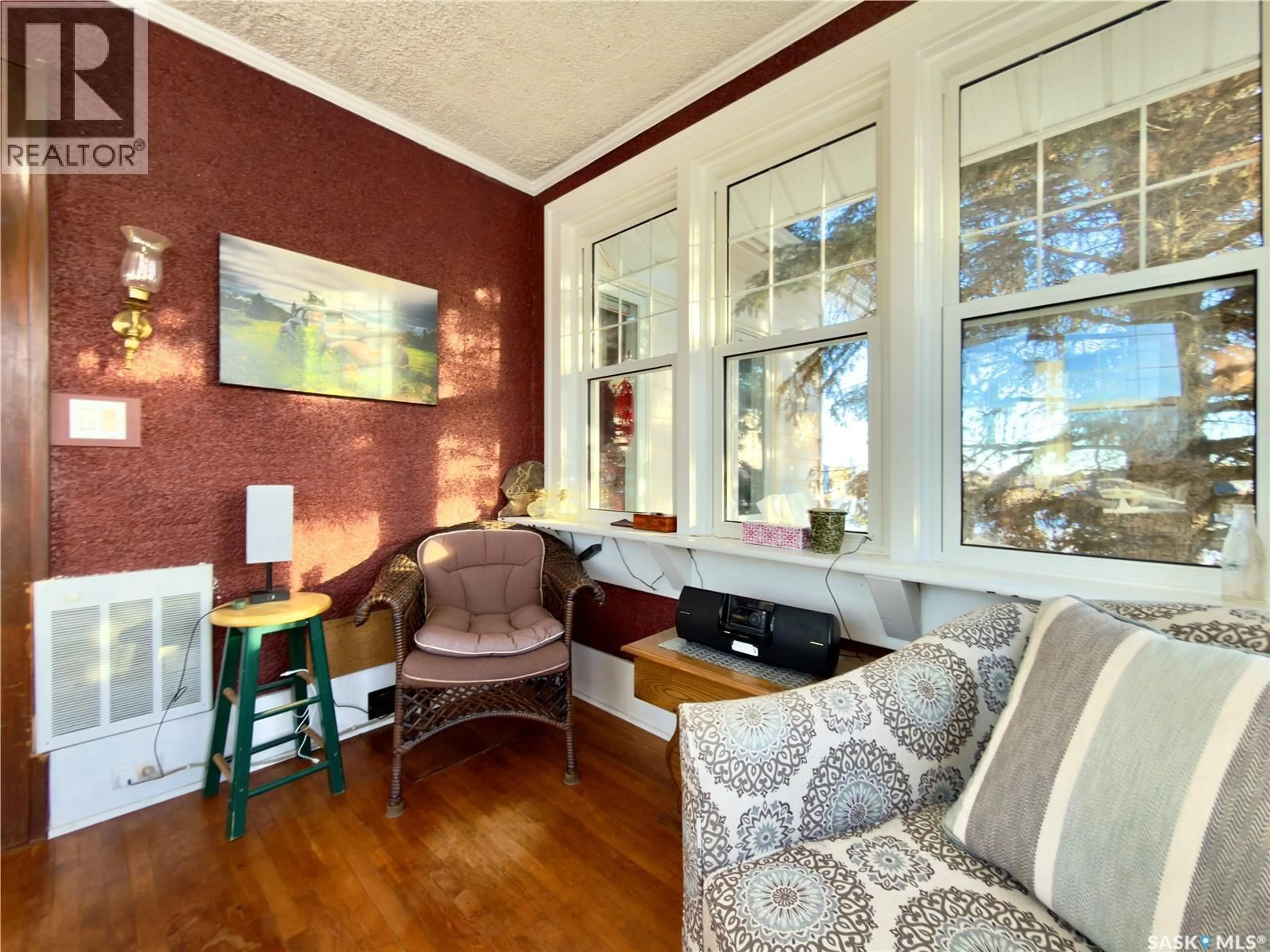 Living room with furniture, wood/laminate floor for SUTTON ACREAGE, Sutton Rm No. 103 Saskatchewan S0H1X0
