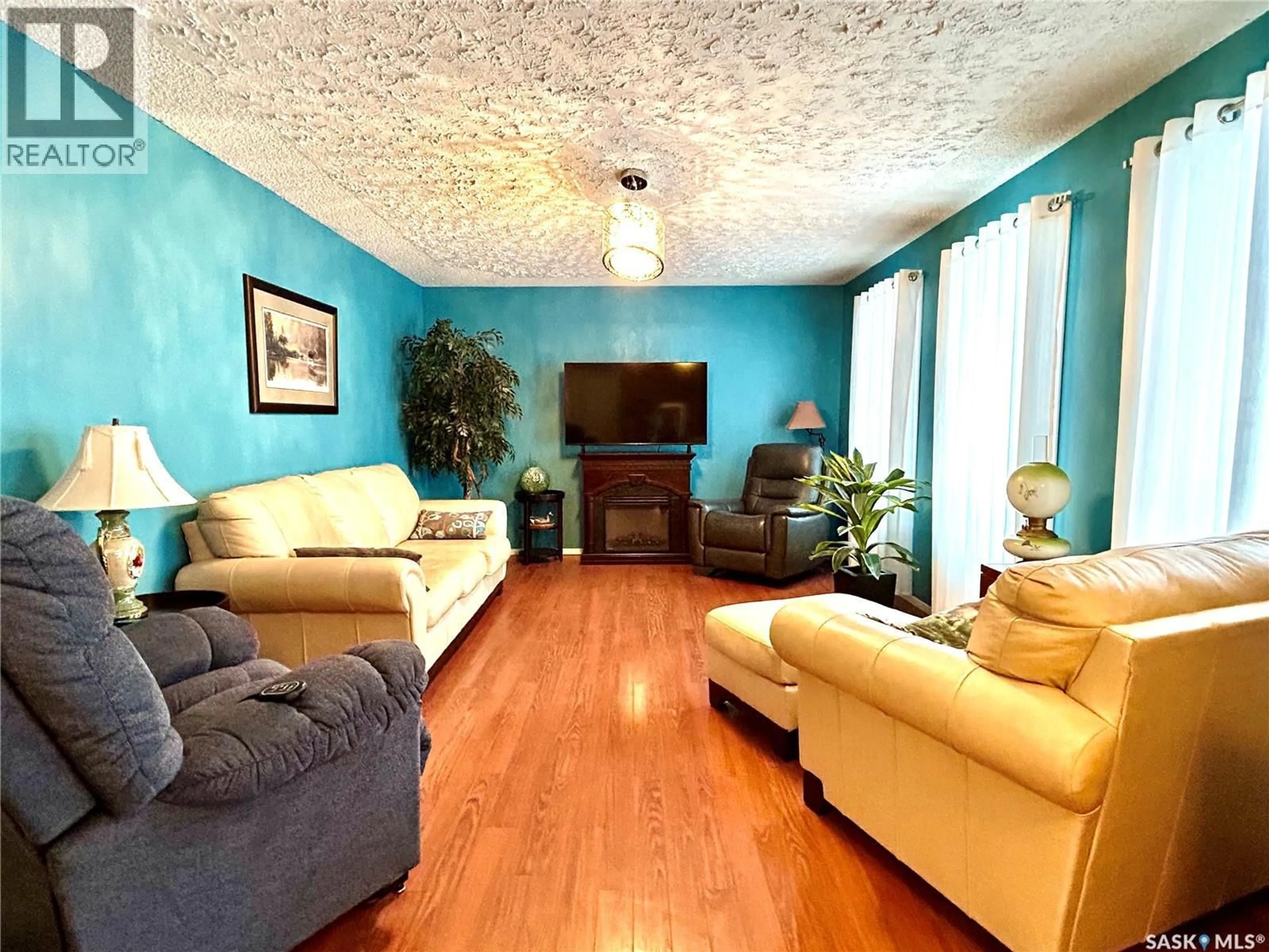 Living room with furniture, wood/laminate floor for 700 9TH AVENUE, Nipawin Saskatchewan S0E1E0