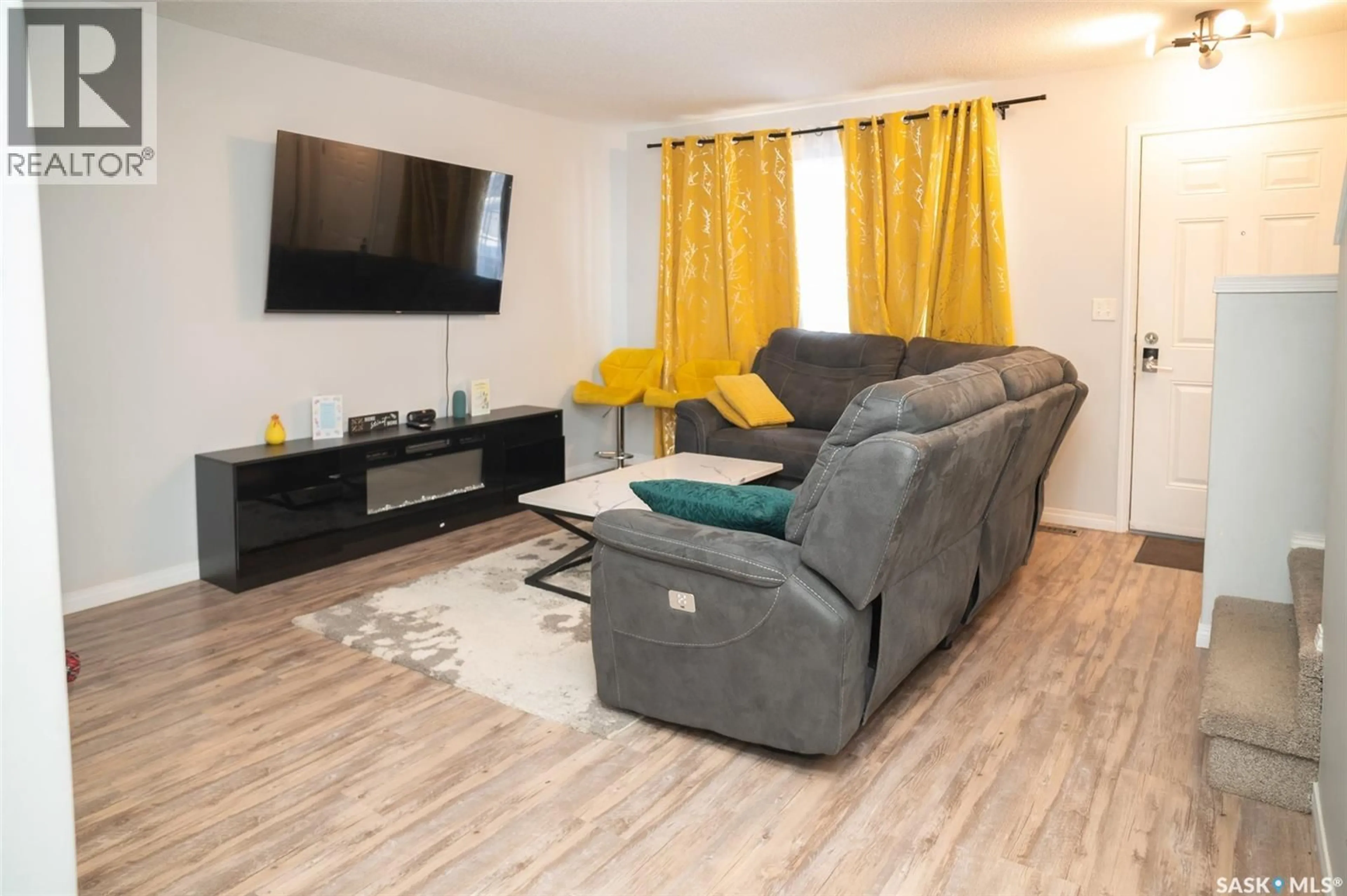 Living room with furniture, wood/laminate floor for 23 135 KEEDWELL STREET, Saskatoon Saskatchewan S7W0A3