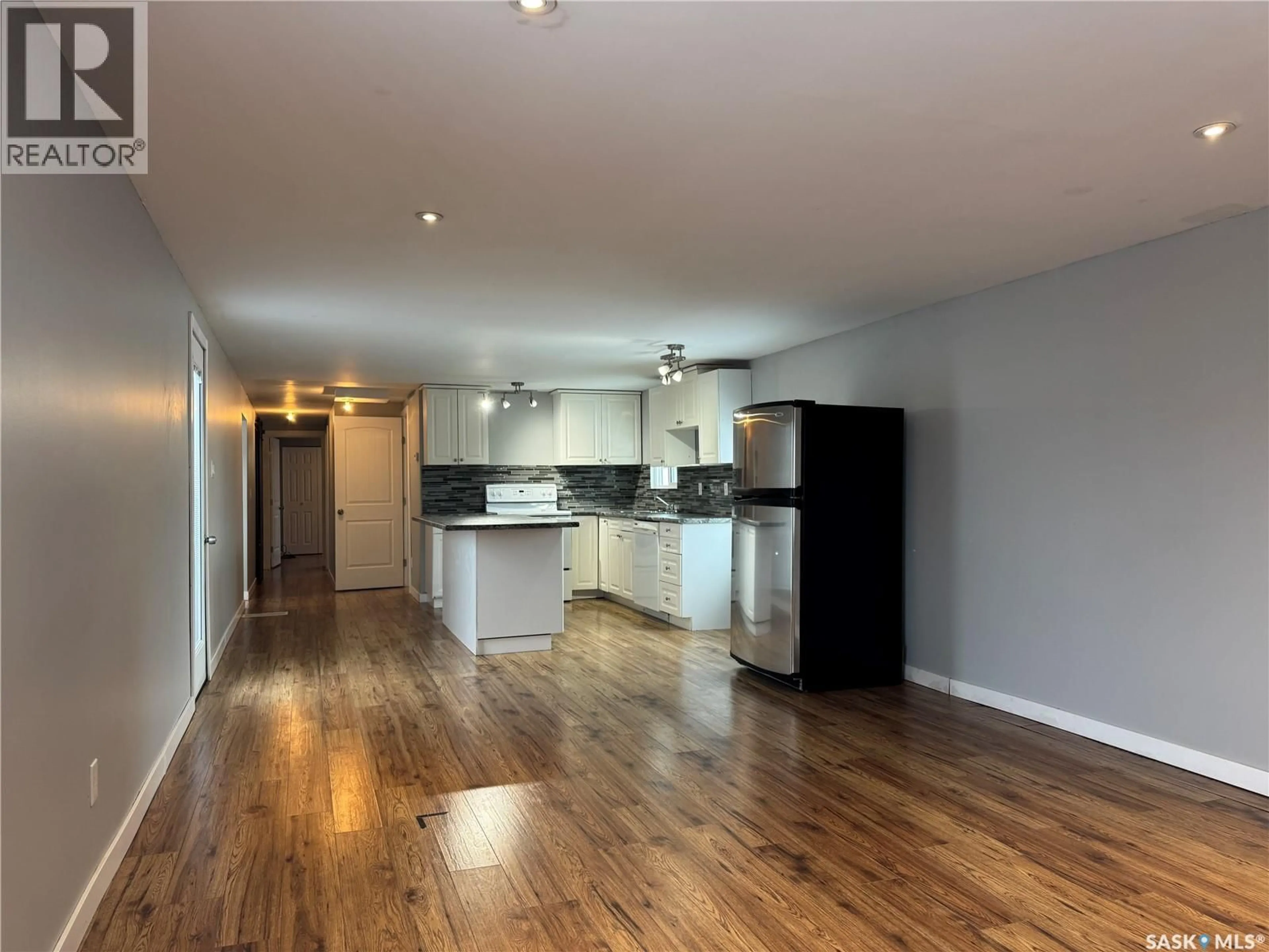 Open concept kitchen, wood/laminate floor for 308 TESKY CRESCENT, Wynyard Saskatchewan S0A4T0